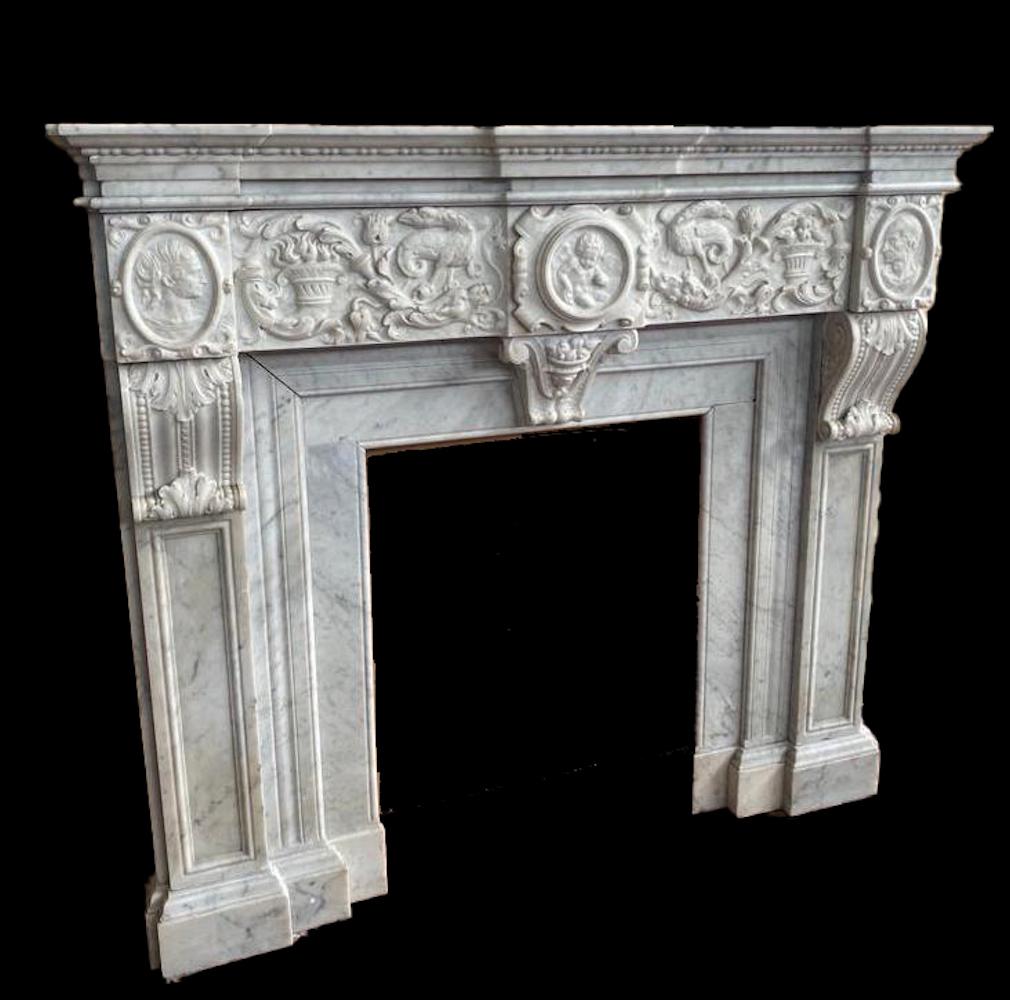 A finely carved Italian Carrara white marble fireplace with shaped frieze, centered with griffons and elegant acanthus leaves decoration. On the sides two ovals representing Julius Caesar and his wife Pompeo Silla .
Provenance from a Roman
