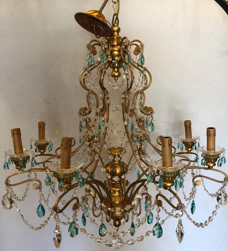 Neoclassical Italian crystal chandelier handcrafted in gilt metal.
Having a pair of matching wall sconce sold separately this sleek and stylish Murano crystal chandelier is reminiscent of the workmanship that has made Alba lighting a household name