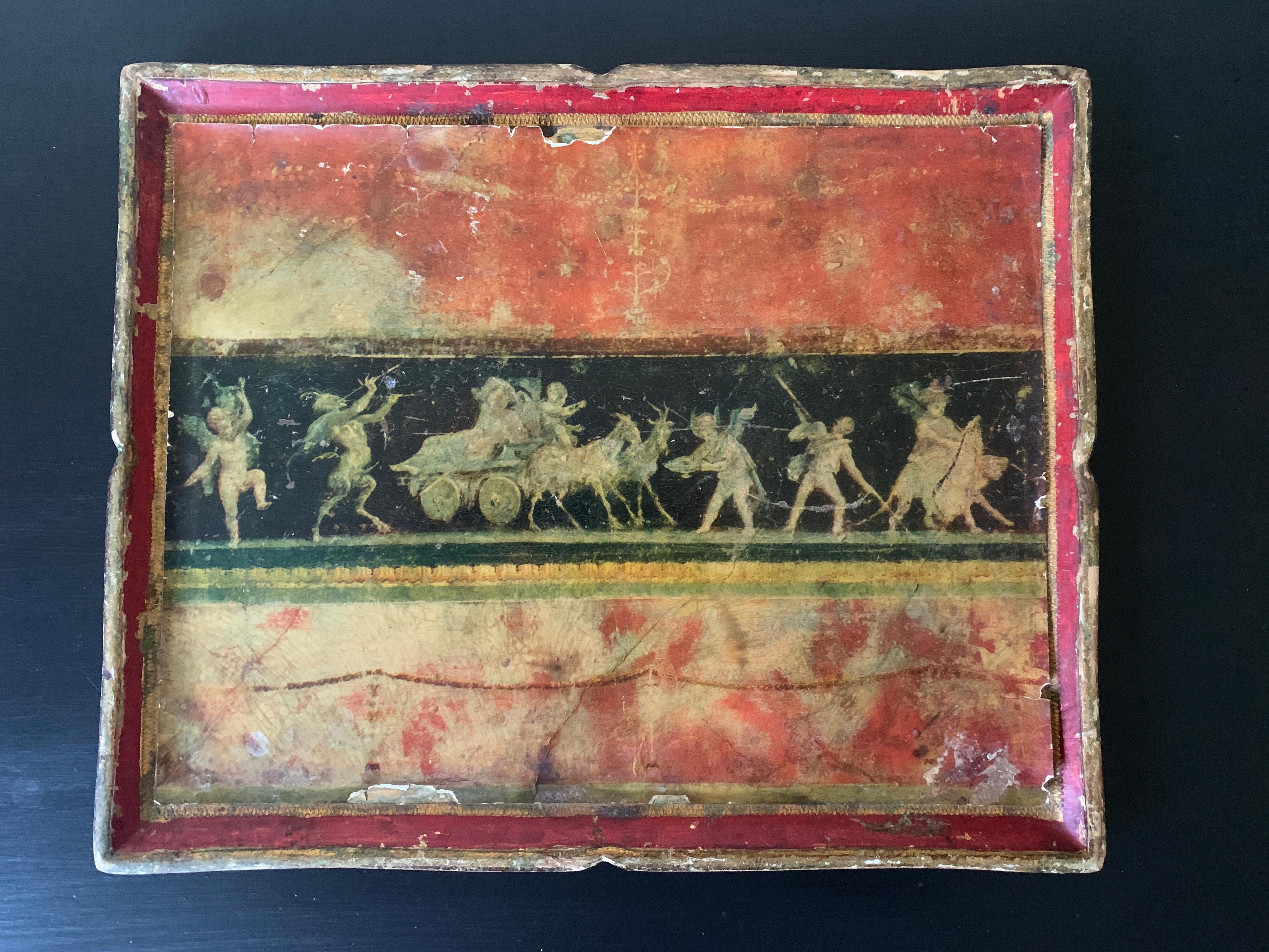 A beautiful Italian Florentine tray featuring a neoclassical scene with putti and mythological figures. This piece would add character and charm to any space.

Italy, Circa 1960s

Giltwood with red, gold, a nd black papier-mâché 

Measures: 15