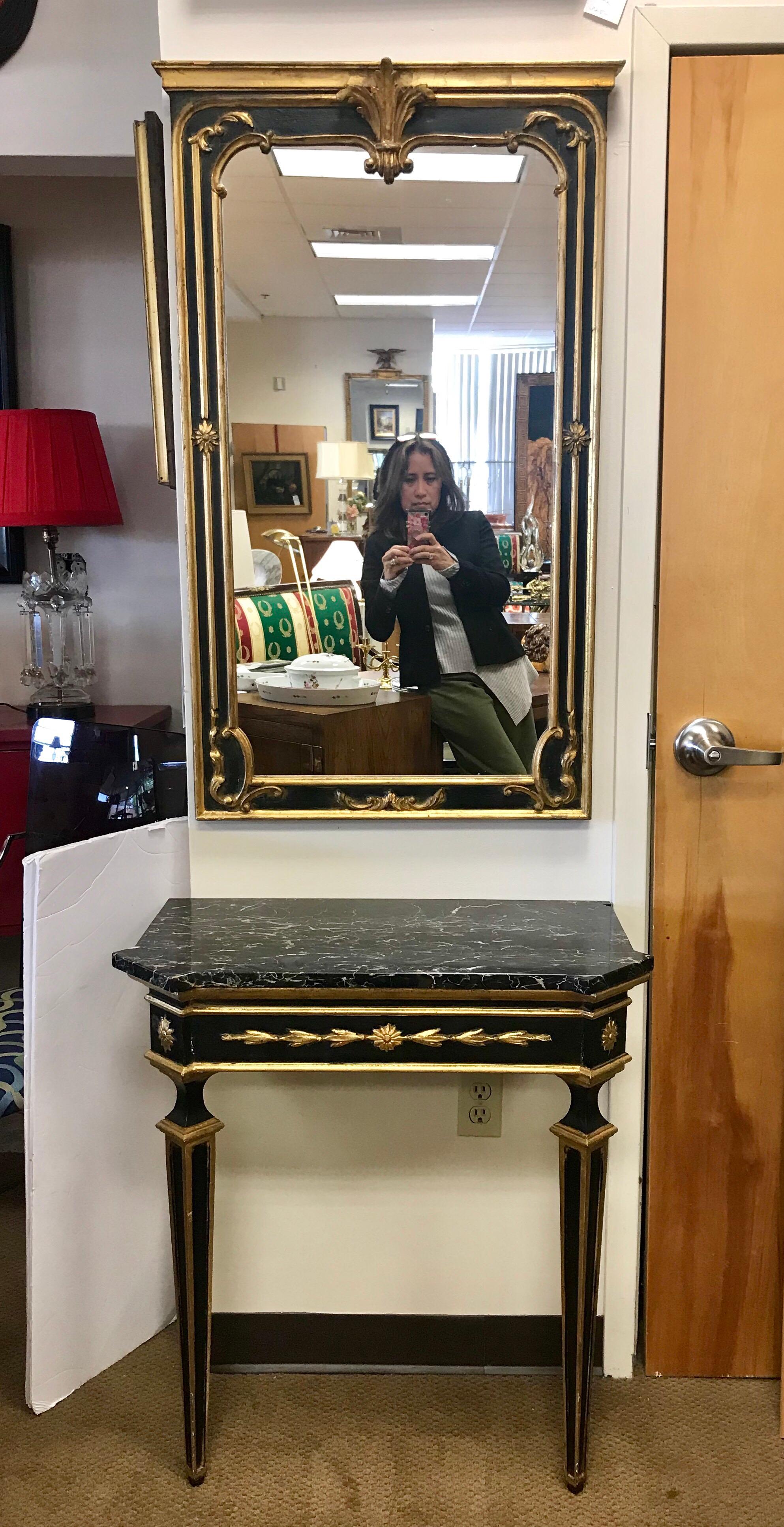 Matching neoclassical giltwood black and gold carved mirror and marble console table. The mirror measures 25 inches wide by 41 inches tall by 1 inch thick and the table dimensions are below.
From Safran & Glucksman, Italy as hallmarked on bottom.
   