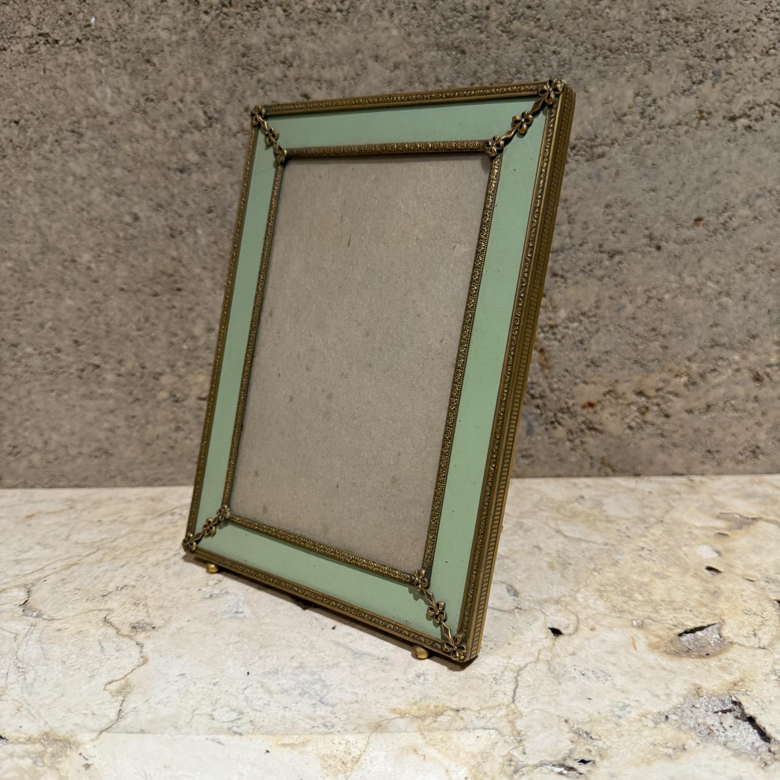 For your consideration:  an Italian Picture Frame. The frame is brass with beautiful ornamentation . It has a light green backdrop and brown velvet on the back. 
Unmarked, no information on the maker. 

Dimensions: 7.5 x 5.5 x .5 d, photo area 5.75