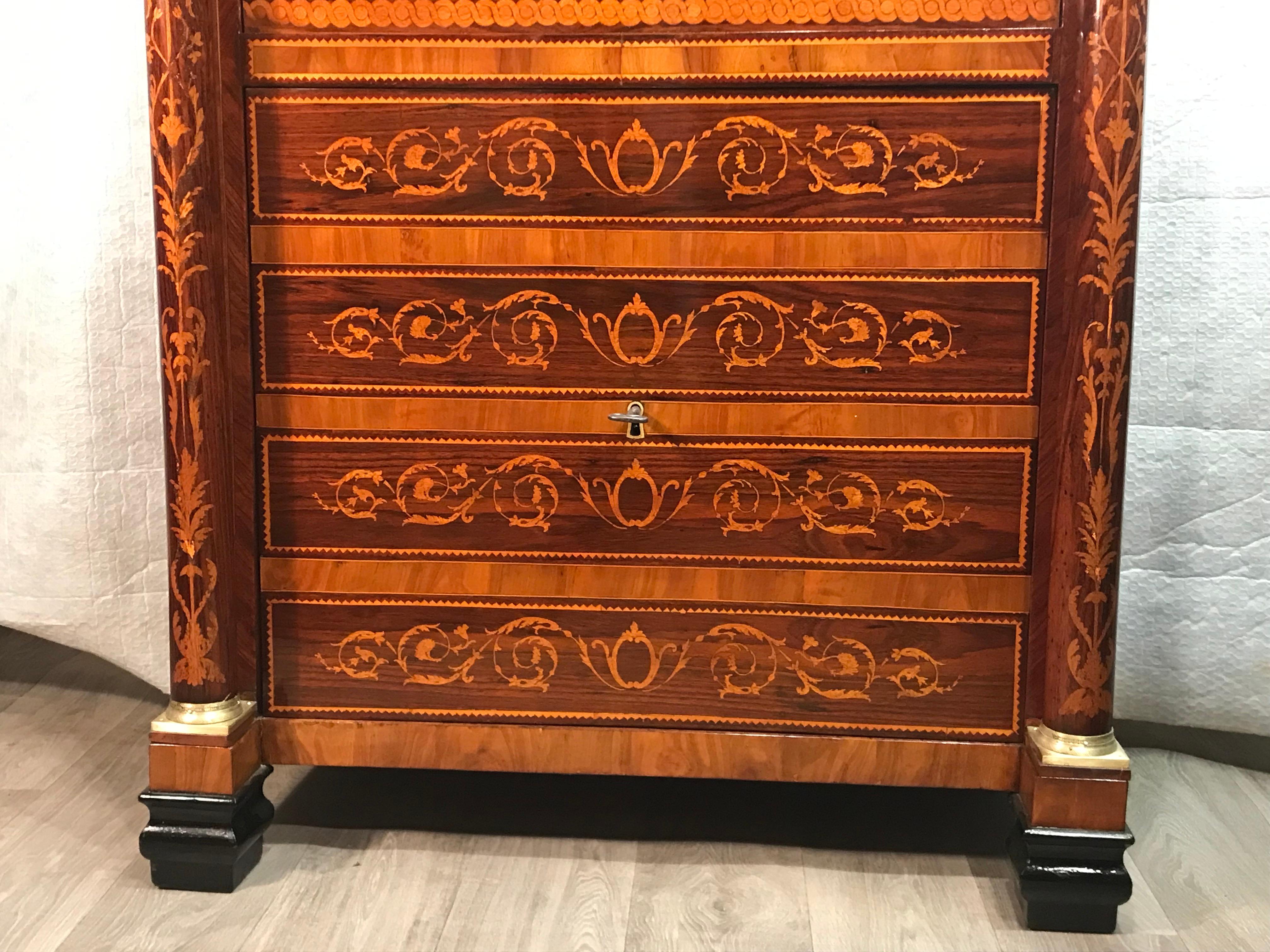 This unique Neoclassical Secretary desk dates back to the beginning of the 19th century, around 1800, and was made in Italy. The secretaire has two columns and a gorgeous marquetry decoration on front and sides. In the lower part it has 4 drawers