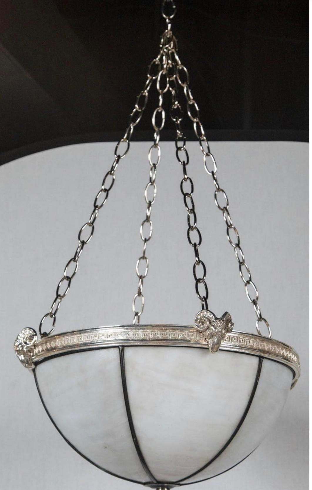 A leaded glass light fixture with interior lights, silver plated Greek key design and ram's head, circa 1920s. In very good vintage condition.

Dealer: G302YP
