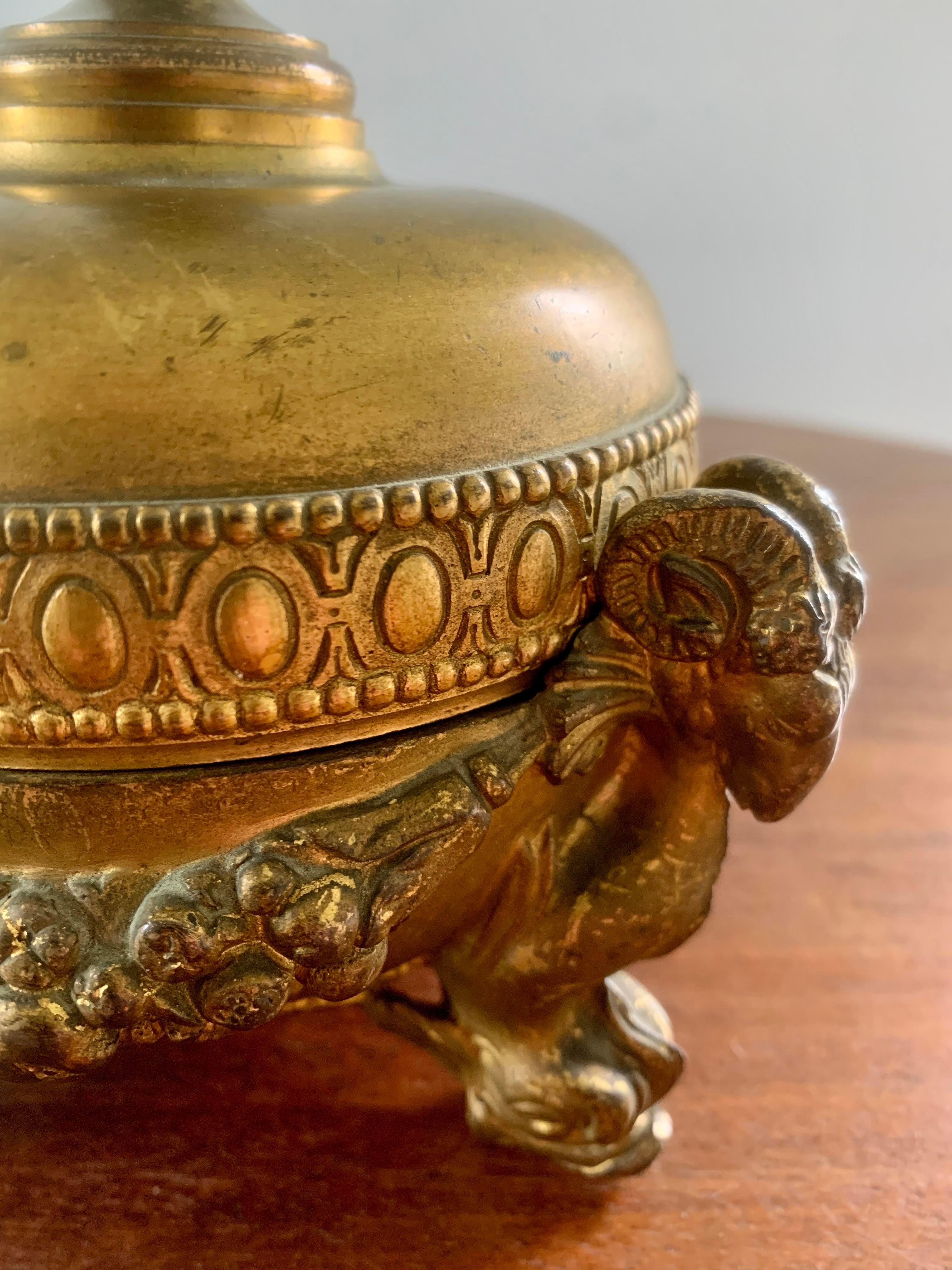 A gorgeous neoclassical grand tour style gilt metal lidded bowl featuring ram's heads and dolphin feet

Circa early 20th century

Measures: 6.25