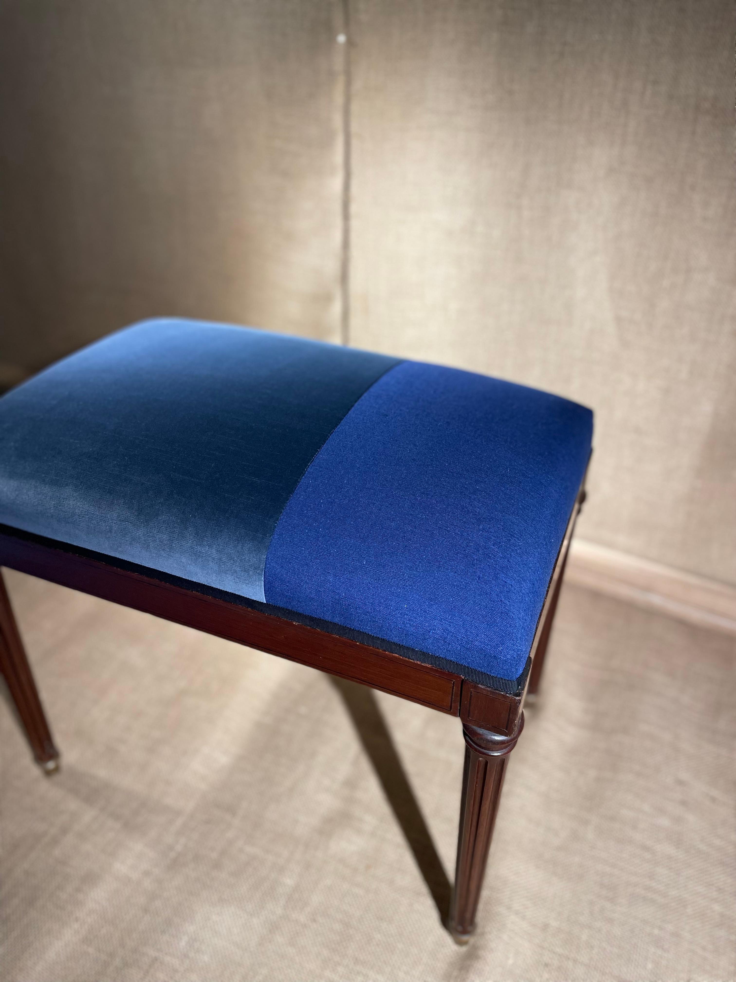 A  Neoclassical Bench created by “Edward Garratt XVII and XIX Century Reproductions,” upholstered in blue velvet and linen fabrics. Circa 20th Century.