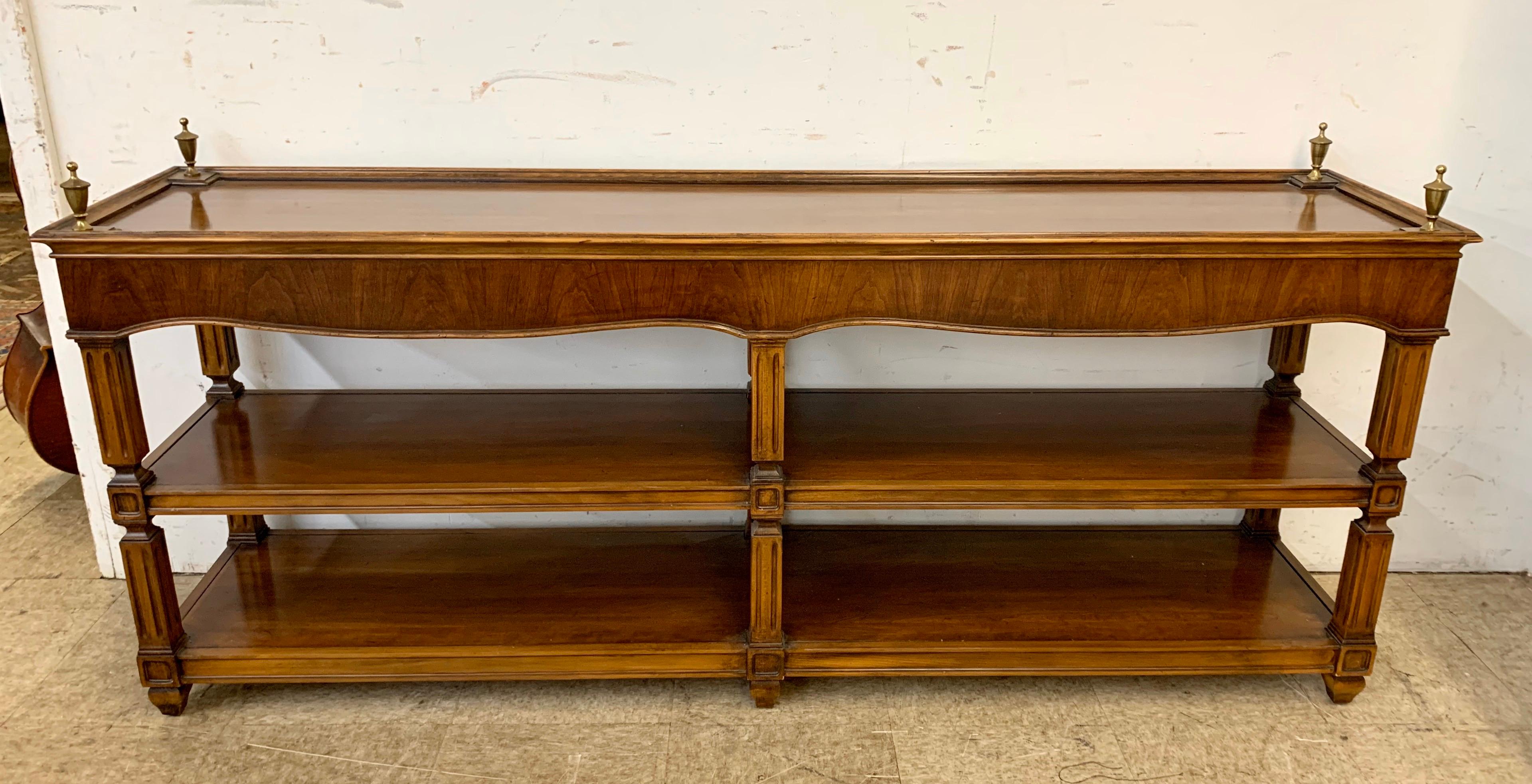 Neoclassical mahogany console table with open shelves and four fluted legs with brass finials. Perfect in your foyer or behind a sofa. Height is 27.25