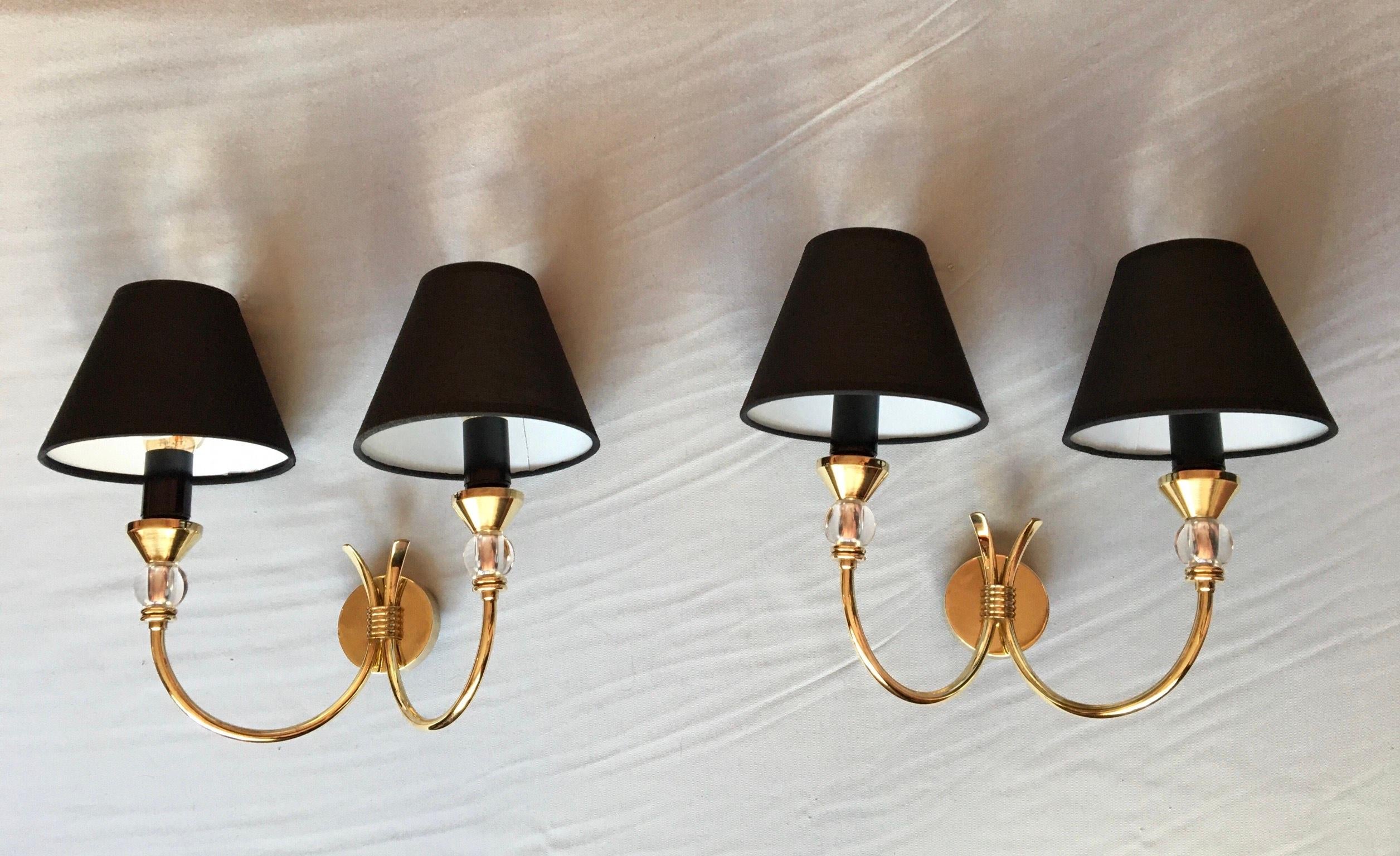 Very chic and stylish pair or French Neoclassical double arm sconces of the 50’s in brass and lucite in the style of Maison Jansen.
The black cotton lamp shades are new and complimentary.
 ( maxi 40 watts )
Electrics parts have been renewed and