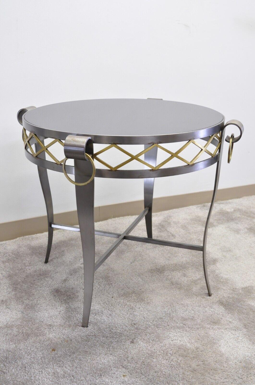 Neoclassical Maison Jansen Style Steel & Black Marble Round Bouillotte Center Table. Item features a heavy steel frame, inset black round marble top, brass x-form detail to skirt, and 4 brass rings, quality Italian craftmanship, great style and