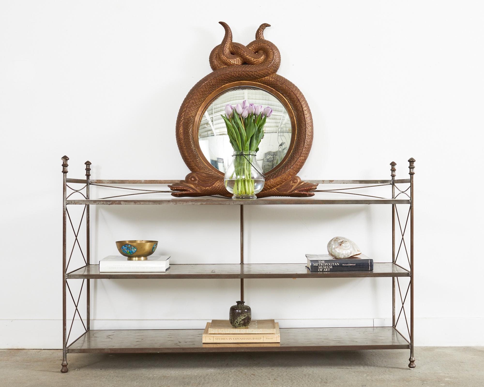 Neoclassical directoire style three-shelf bookcase or display shelf made in the style and manner of Maison Jansen. The case features three shelves measuring 4, 16, and 29 inches high with a turned finish on the tops. The shelves are supported by