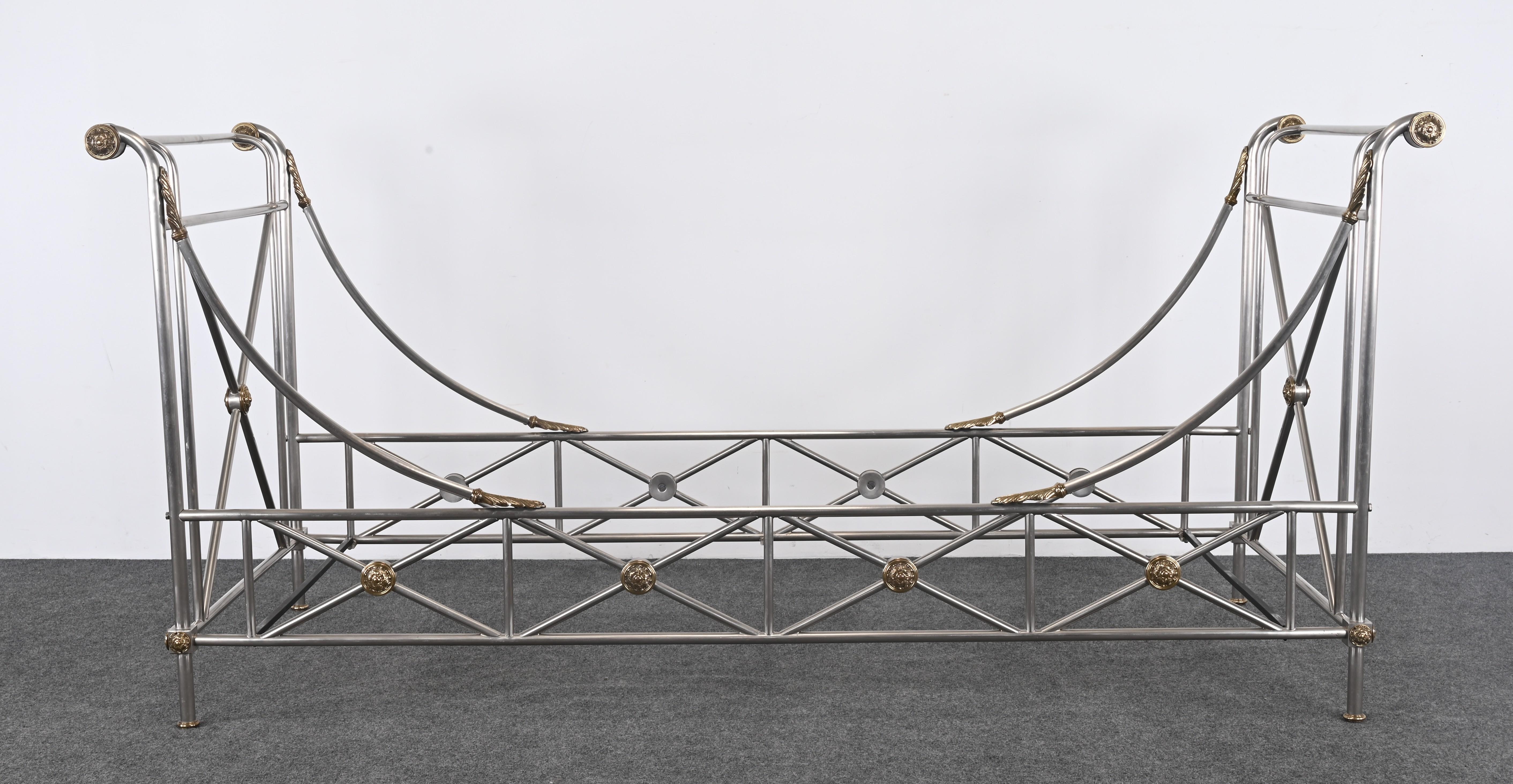 A Neoclassical steel and brass daybed in the manner of Maison Jansen. This stunning steel daybed is accented with brass Neoclassical medallions. 

It is in very good condition and includes three metal mattress supports. It disassembles, making it