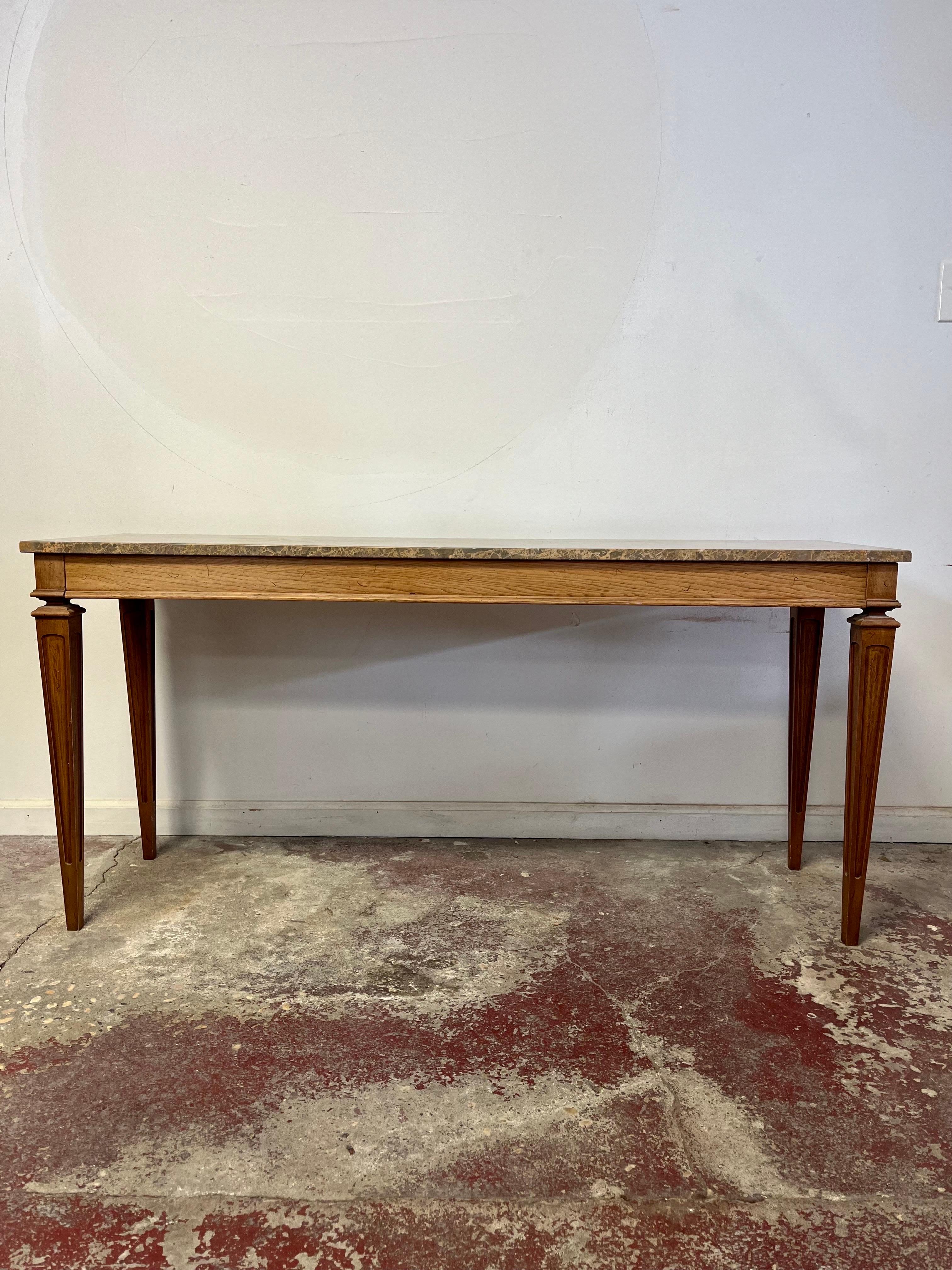 Beautiful in it's simplicity. Neoclassical console table with nicely tapered legs.   Complementing marble top surface. 
Curbside to NYC/Philly $300