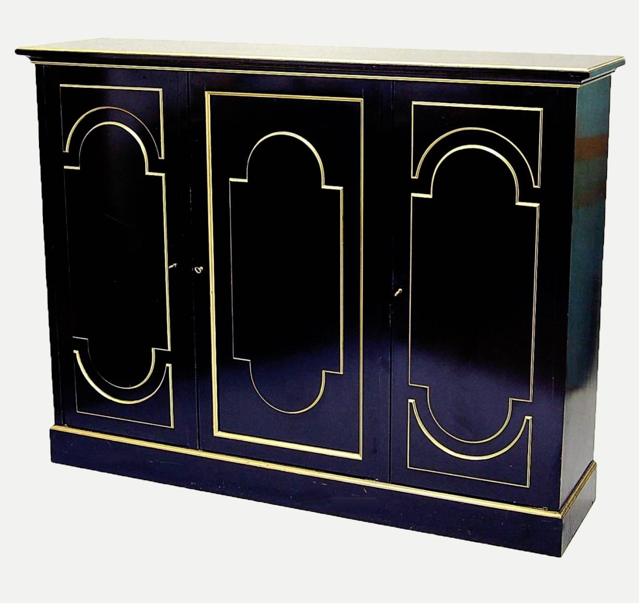 This luxurious cabinet is signed by neoclassical designer Maurice Hirsch. Typical of the designer, the piece was inspired by the nineteenth century, albeit with a contemporary twist. Rich, dark wood makes up the body of the cabinet, and it’s been