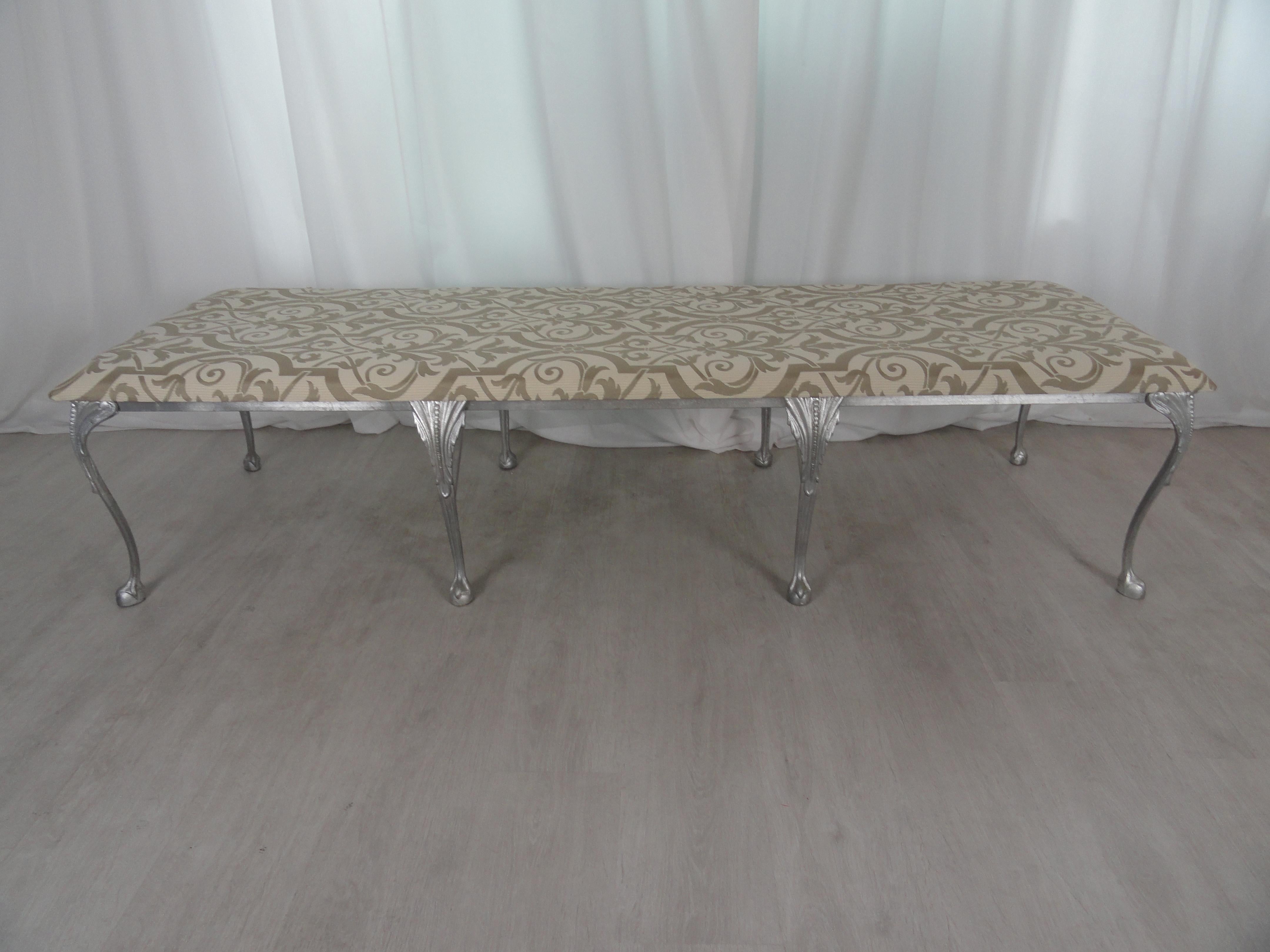 Neoclassical style metal and upholstered bench. Eight leg bench with ball and claw legs in silver finish. Upholstered in contemporary damask. Large-scale.