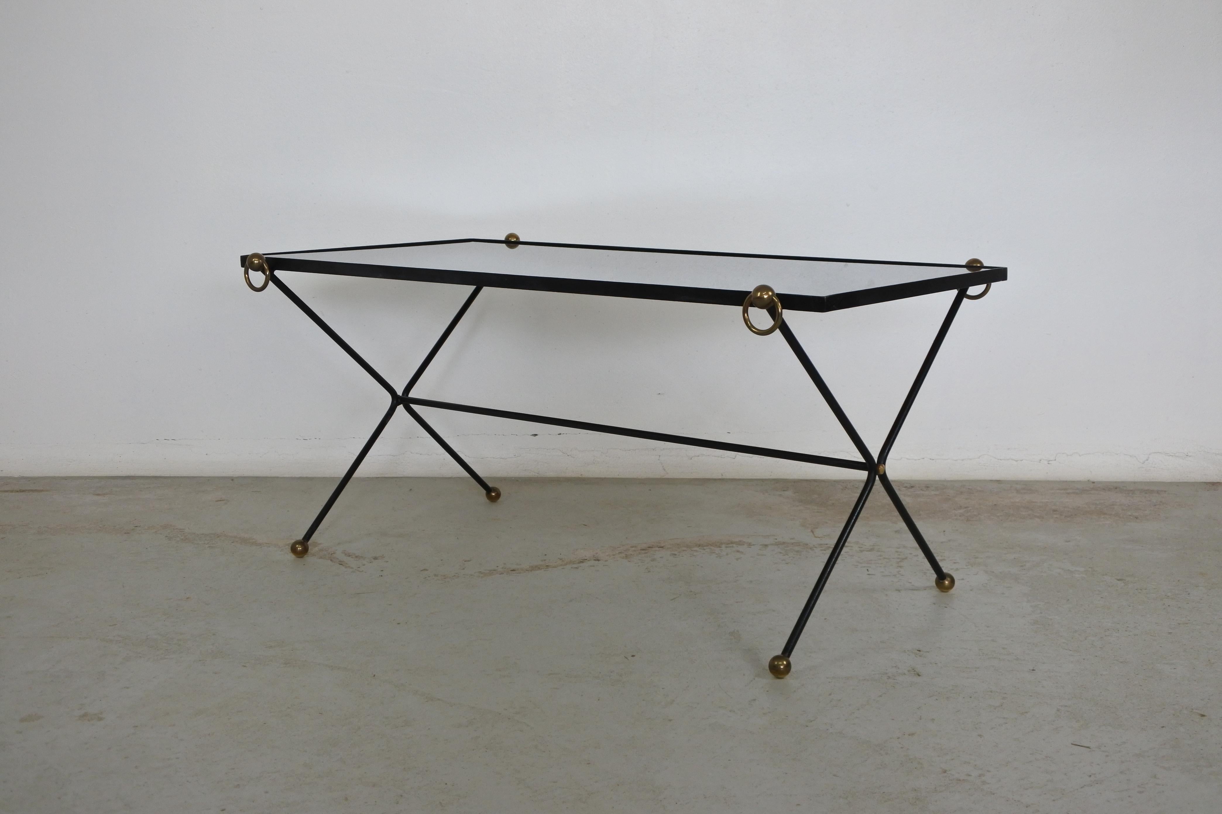 Neoclassic coffee table.
Black lacquered metal frame with a black opaline glass top and brass accent.
Made in France in the 1950s.