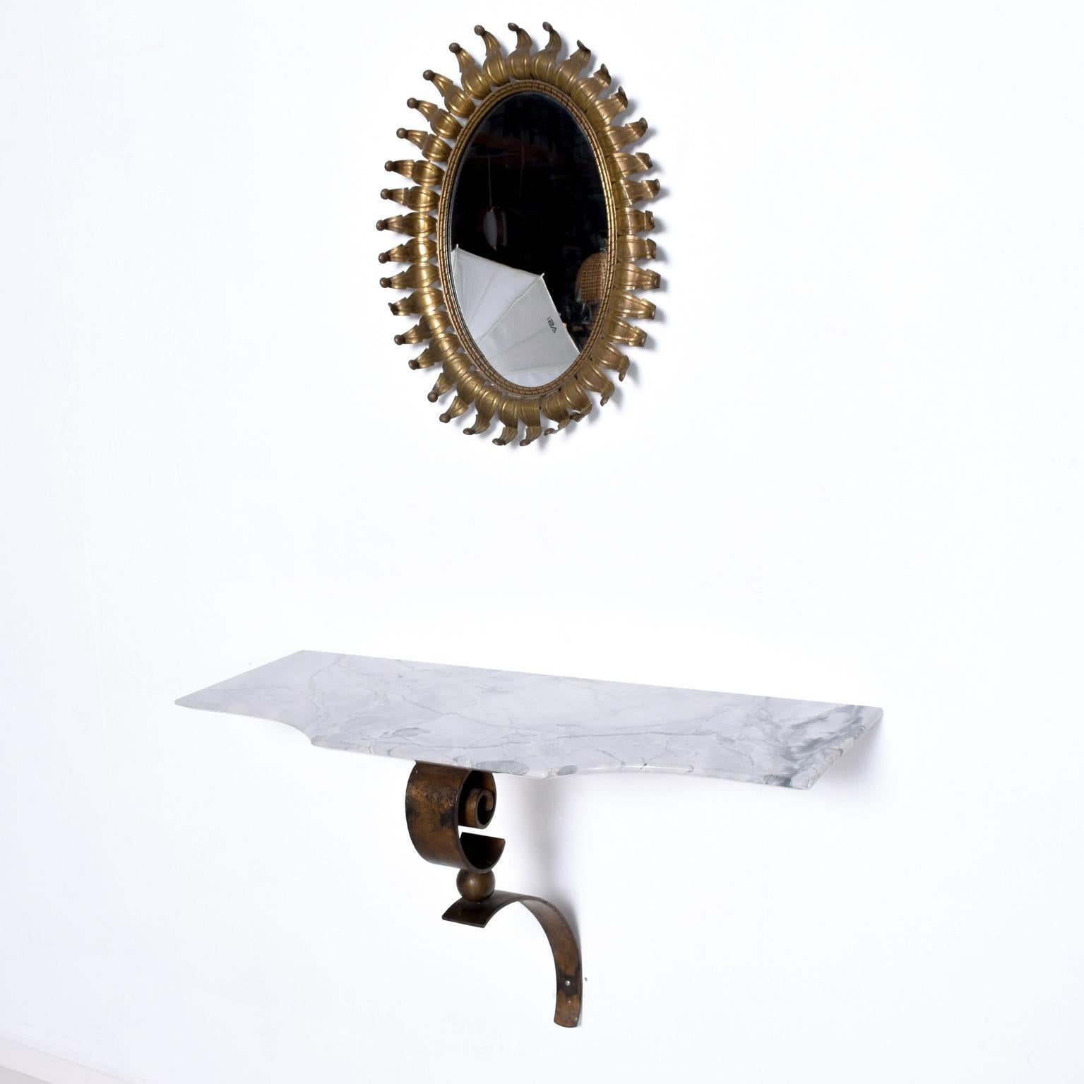 We are pleased to offer for your consideration, a stunning wall console constructed with forged iron, bronze and gray marble. The iron frame has a gold leaf patinated finish with a bronze ball in the center. The top is made Italian marble with gray