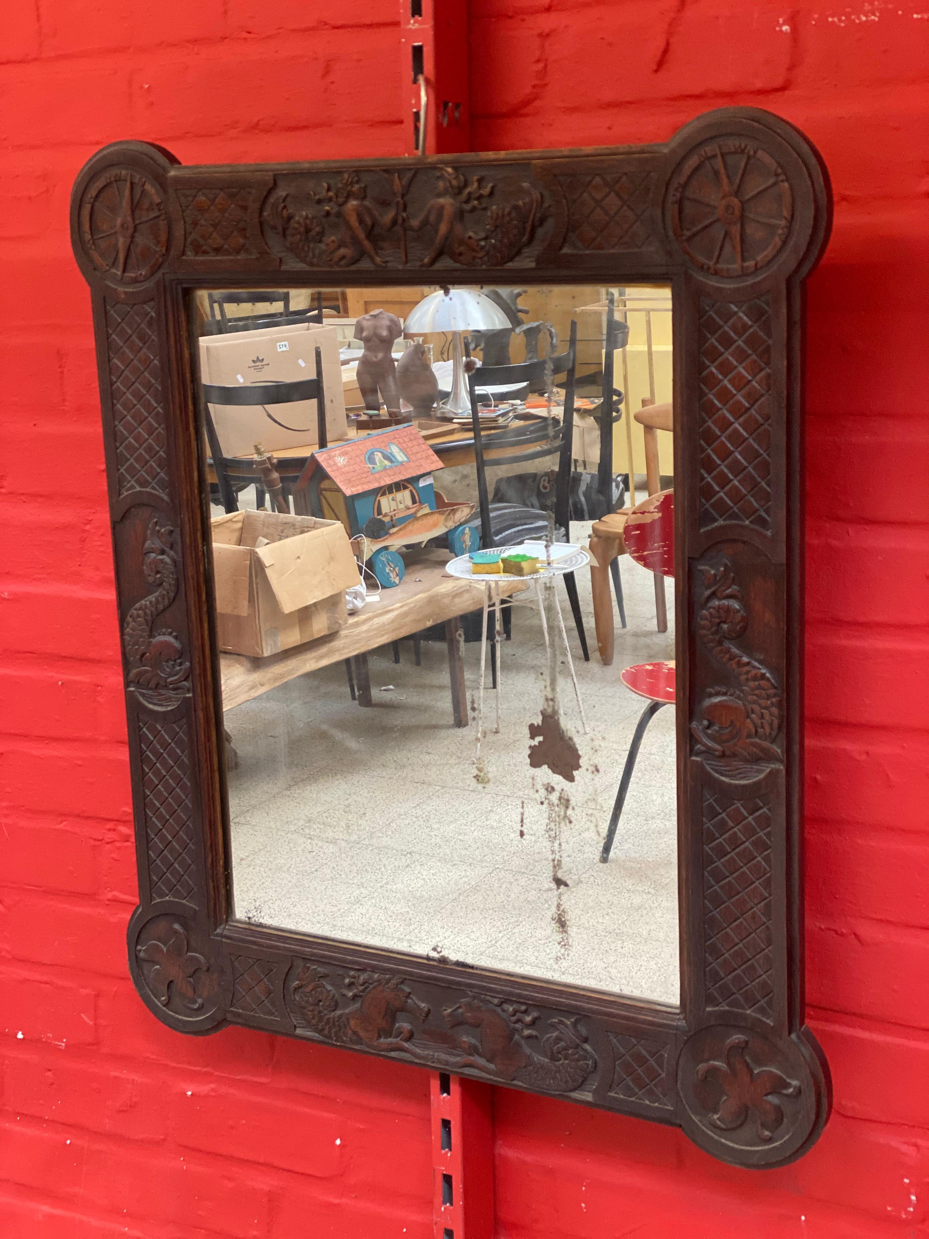 Neoclassical mirror in oak circa 1940/1950
decorated with mermaids, newts ..... and fantastic animals 
the frame is in very good condition, but the mirror is very worn.