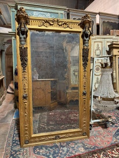 Neoclassical mirror in richly carved wood with caryatids and gilded, Italy