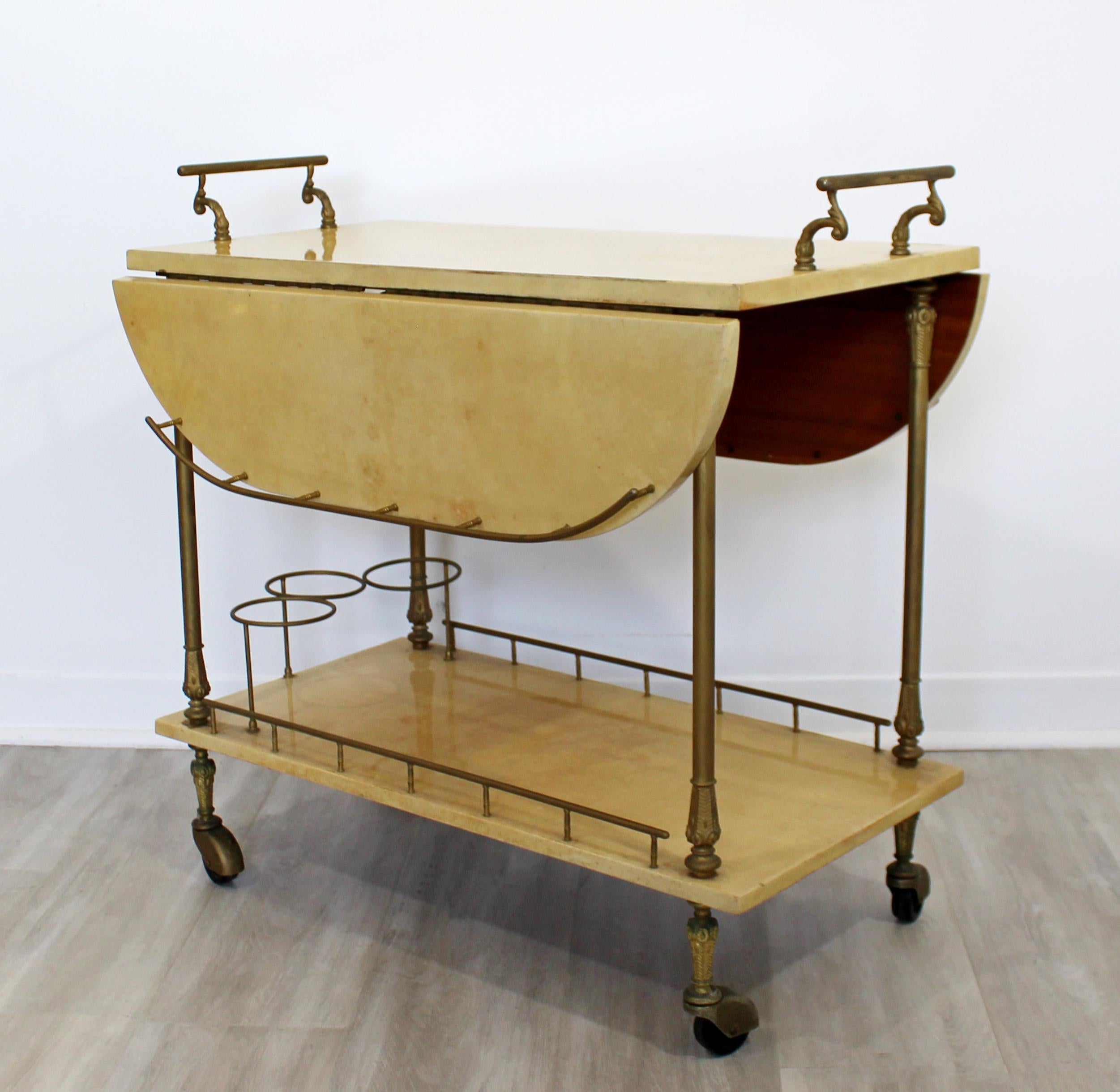 For your consideration is a magnificent, two-tier rolling bar or service cart, made of lacquered goatskin and brass, by Aldo Tura, made in Italy, circa 1960s. In excellent vintage condition. The dimensions are 31.5