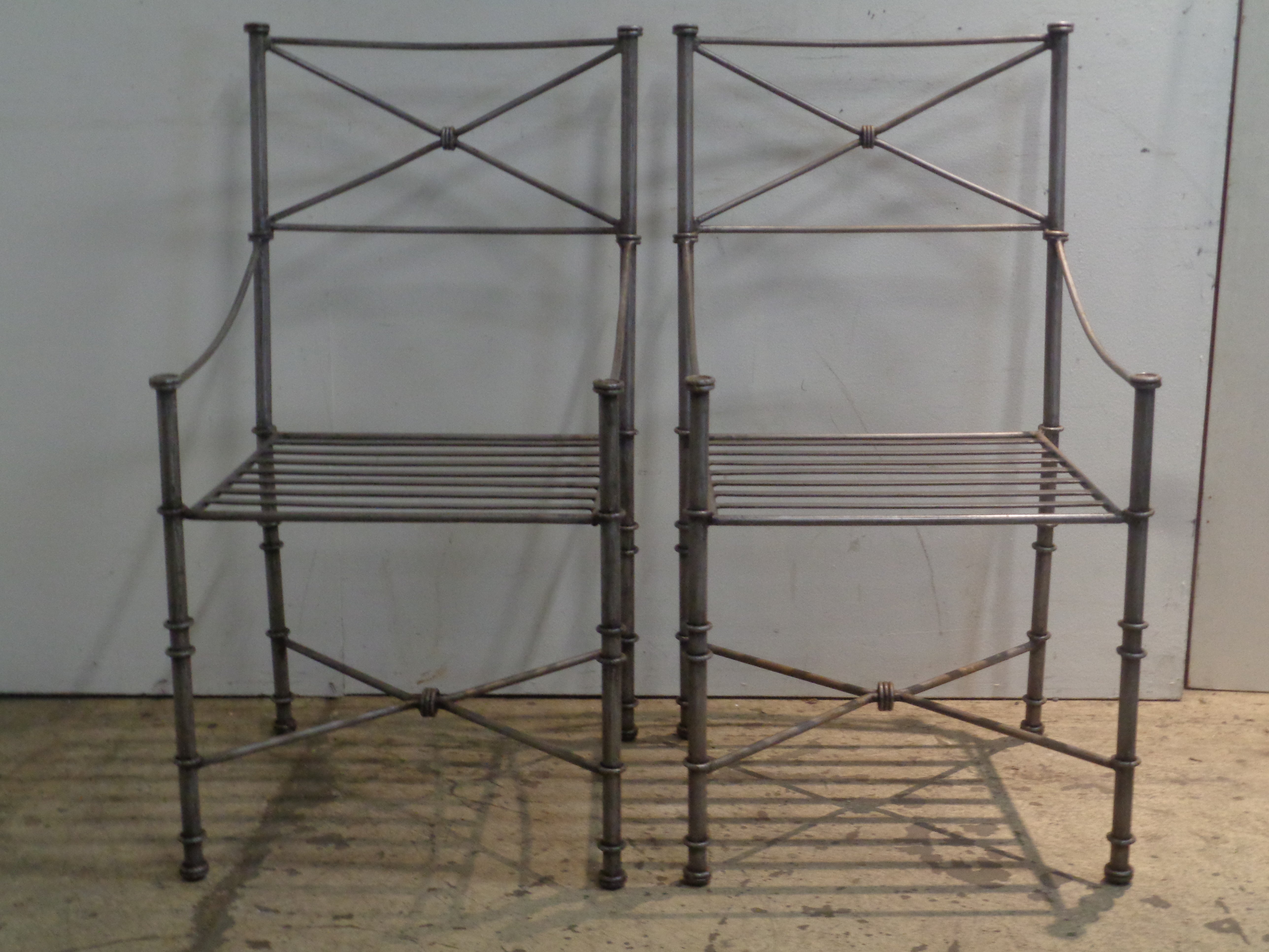 A good looking set of four neoclassical modern iron armchairs in the original silvered finish. Style of Diego Giacometti. Circa 1980-1990. Dining / occassional chairs. Exterior or interior use. Beautiful condition. Measure 38