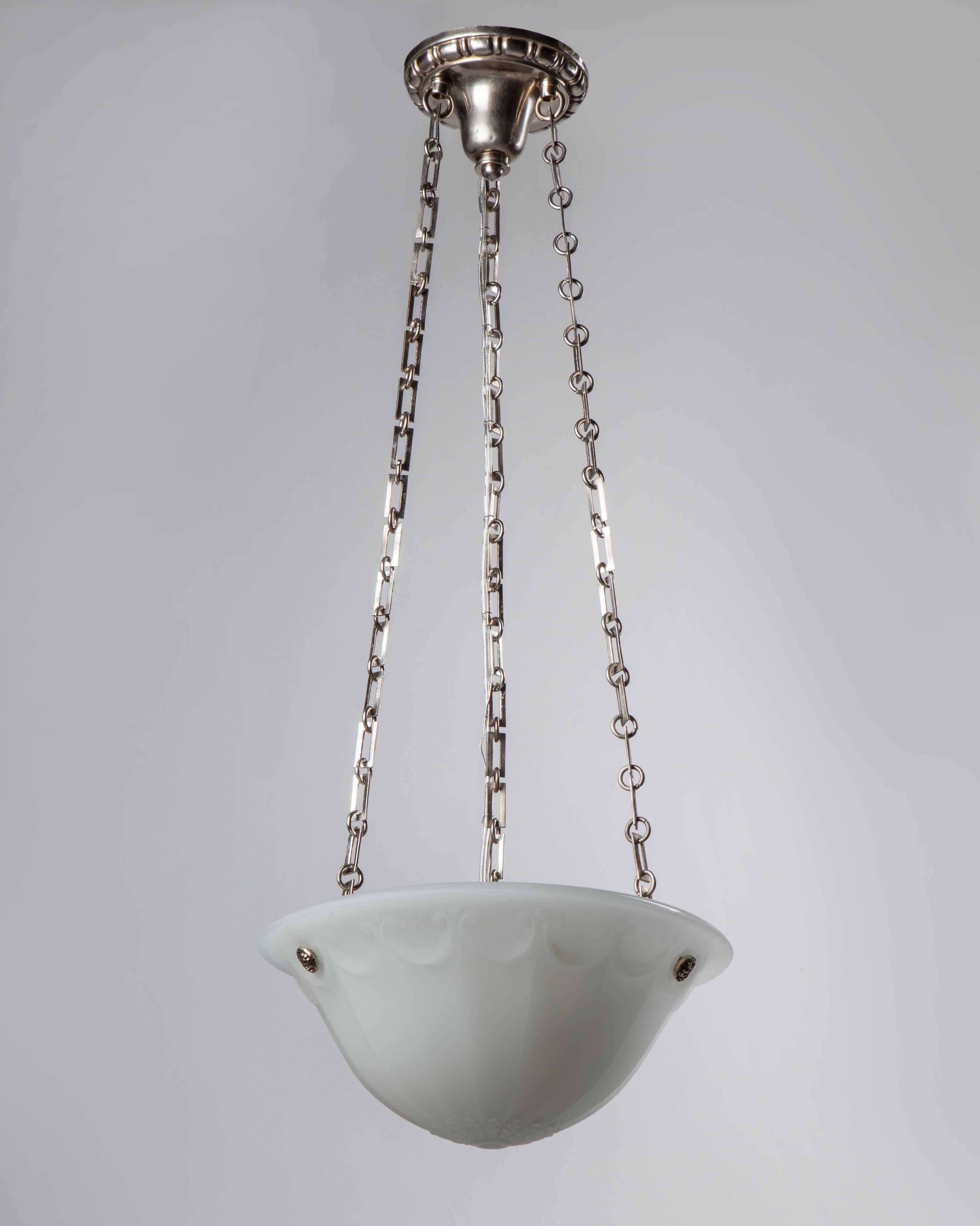 AHL3964

A petite cast opaline glass chandelier with darkened nickel metalwork, circa 1910. Due to the antique nature of this fixture, there may be some nicks or imperfections in the glass as well as variations from piece to