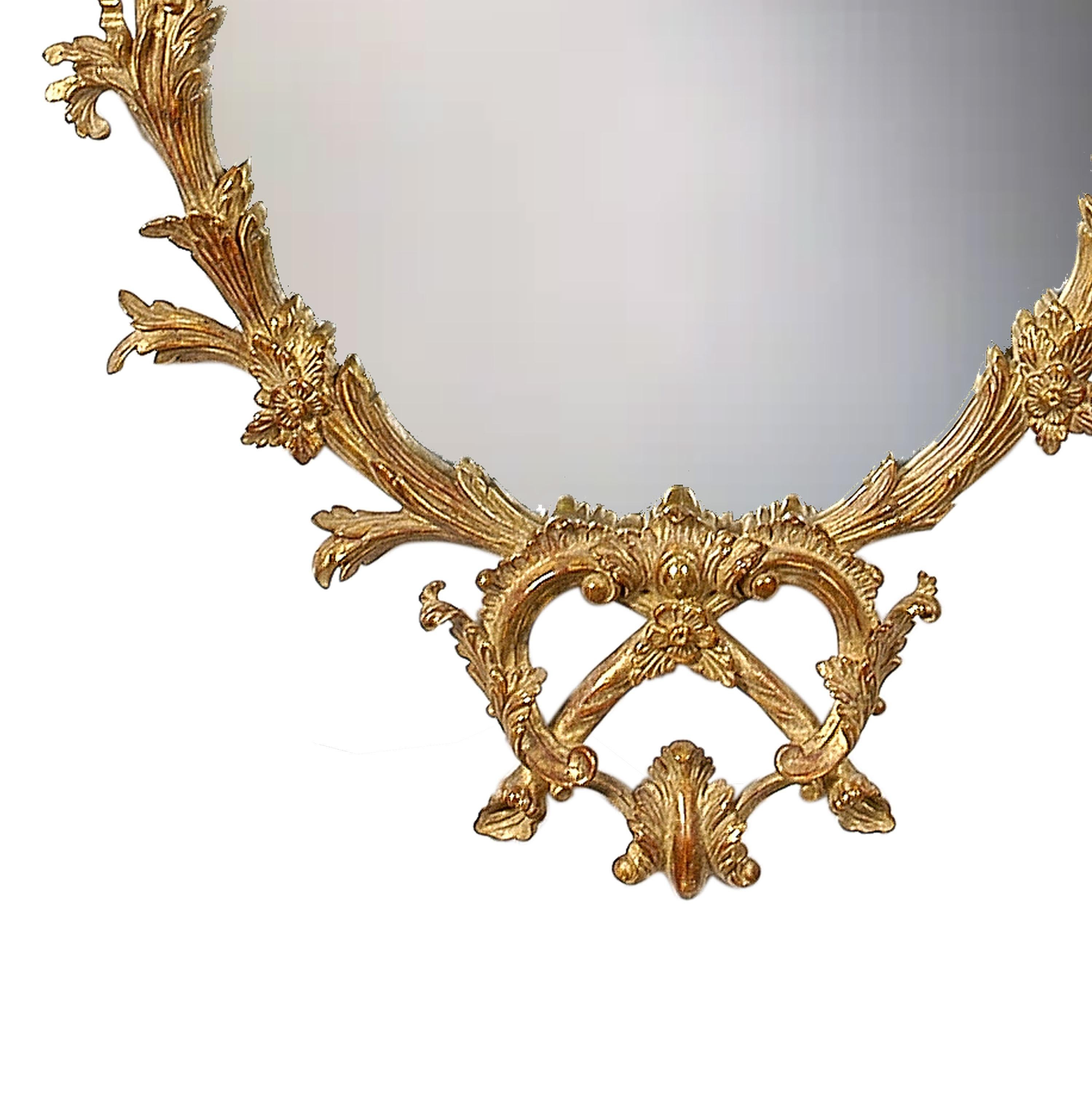 Neoclassical oval handcrafted mirror. Oval hand carved wooden structure with gold foil finished. Spain, 1970.