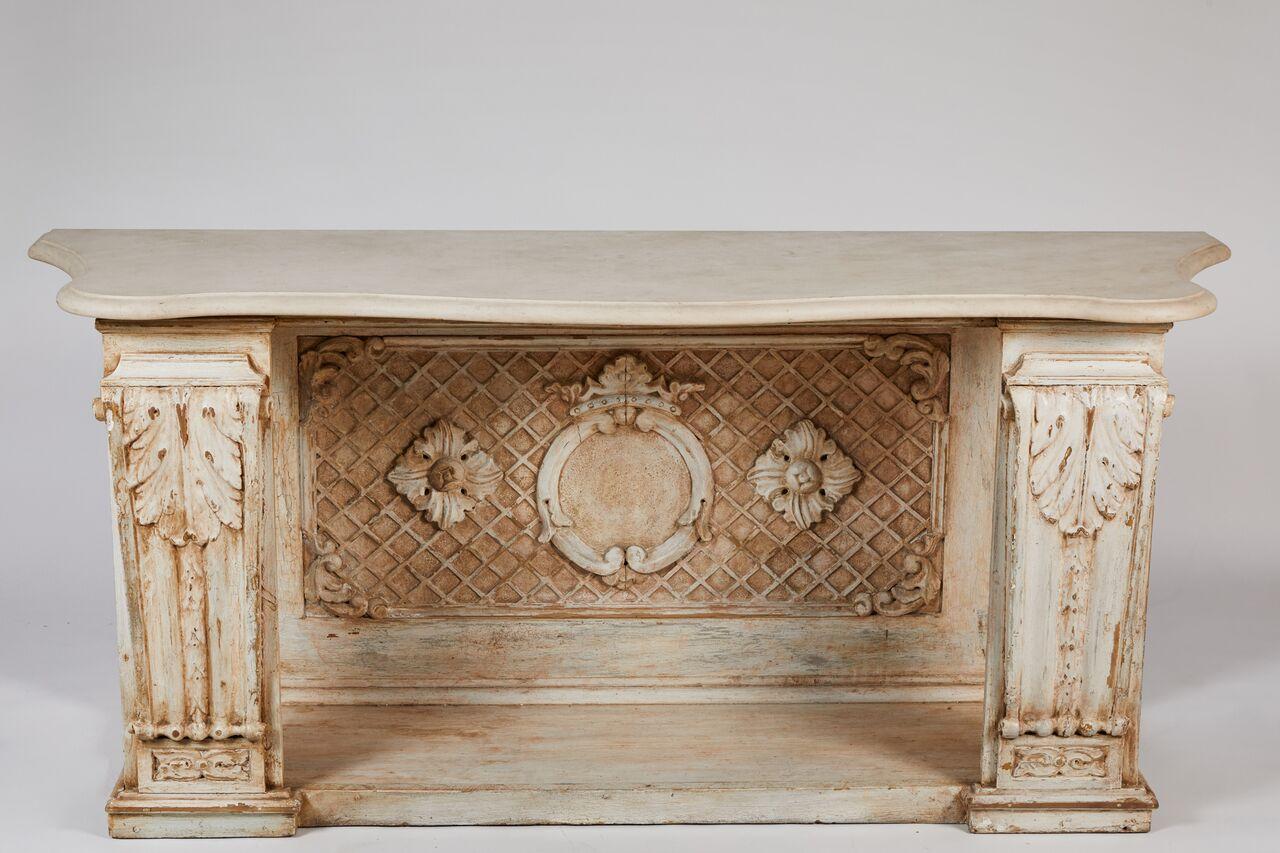 Neoclassical painted wood console from the second half of the 19th century with a light green shaped marble top. The supports feature large-scale acanthus leaves and the back boasts a centre wreath set atop a charming trellis, flanked by