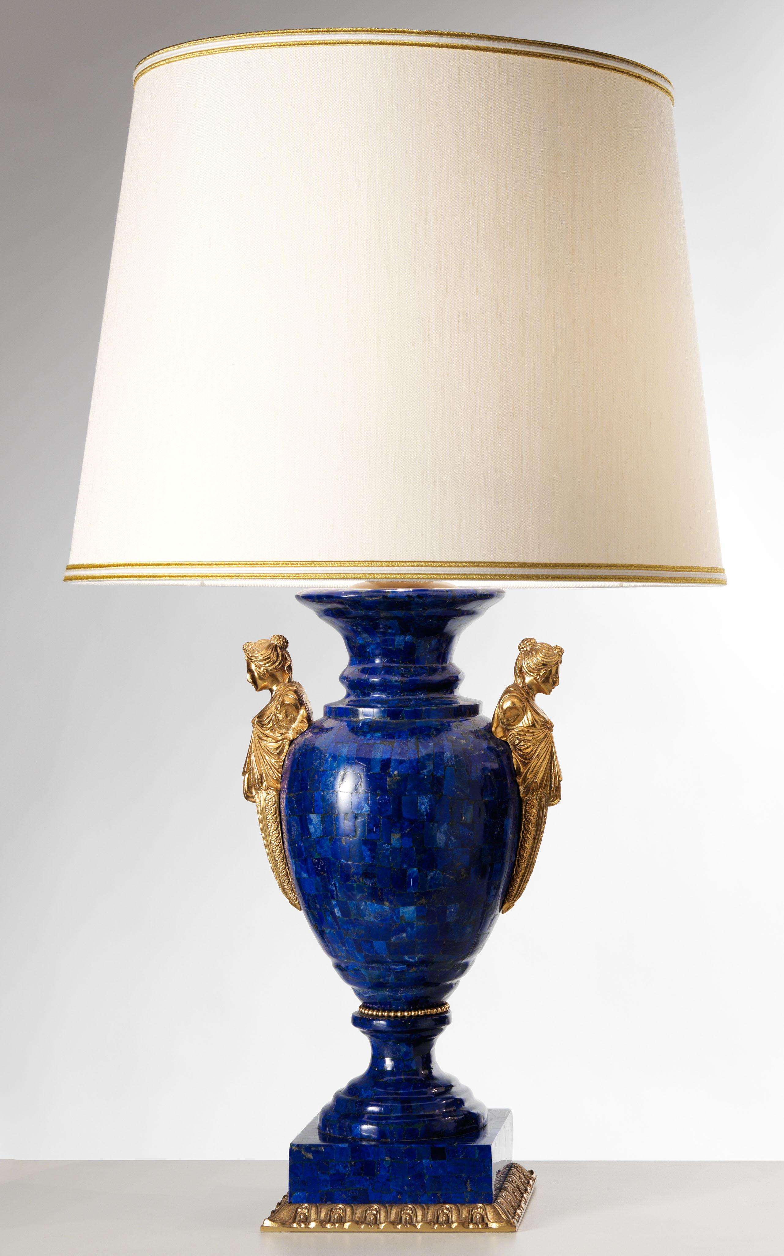 This Neoclassical Style Set of Lapis Lazuli and Gilt Bronze Vase Lamps by Gherardo Degli Albizzi are exceptional pieces of luxury design. Vases, which have an ovoid form, feature bulbous bodies veneered all-over in lapis lazuli. Bodies are flanked