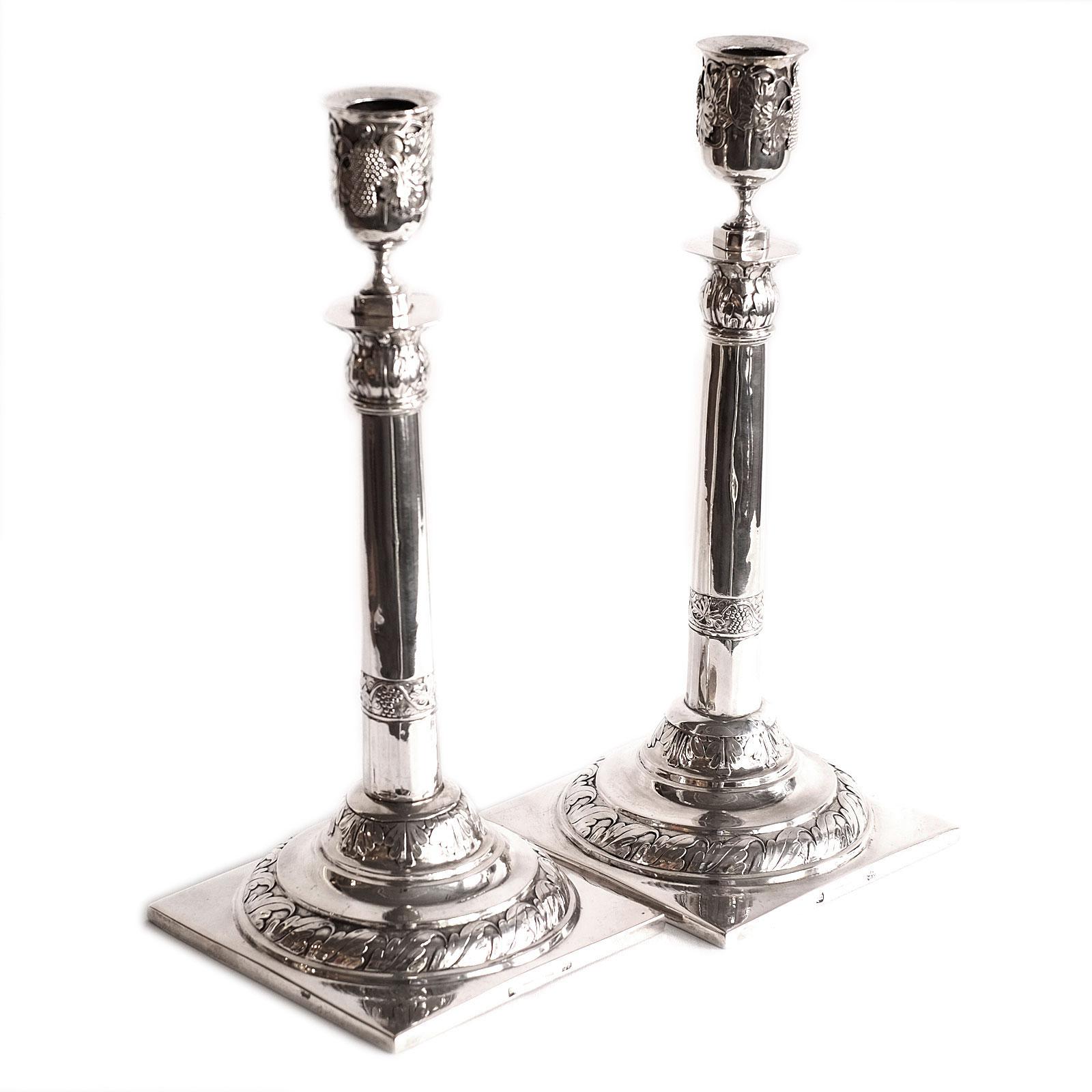 Neoclassical Pair of Silver Candlesticks A.F Burgmüller Leipzig Weissenfels 1820

Large, elegant candlesticks on a square plinth and a stepped round base surrounded by leaf borders, the column shaft decorated with vine leaf frieze and leaf capital,
