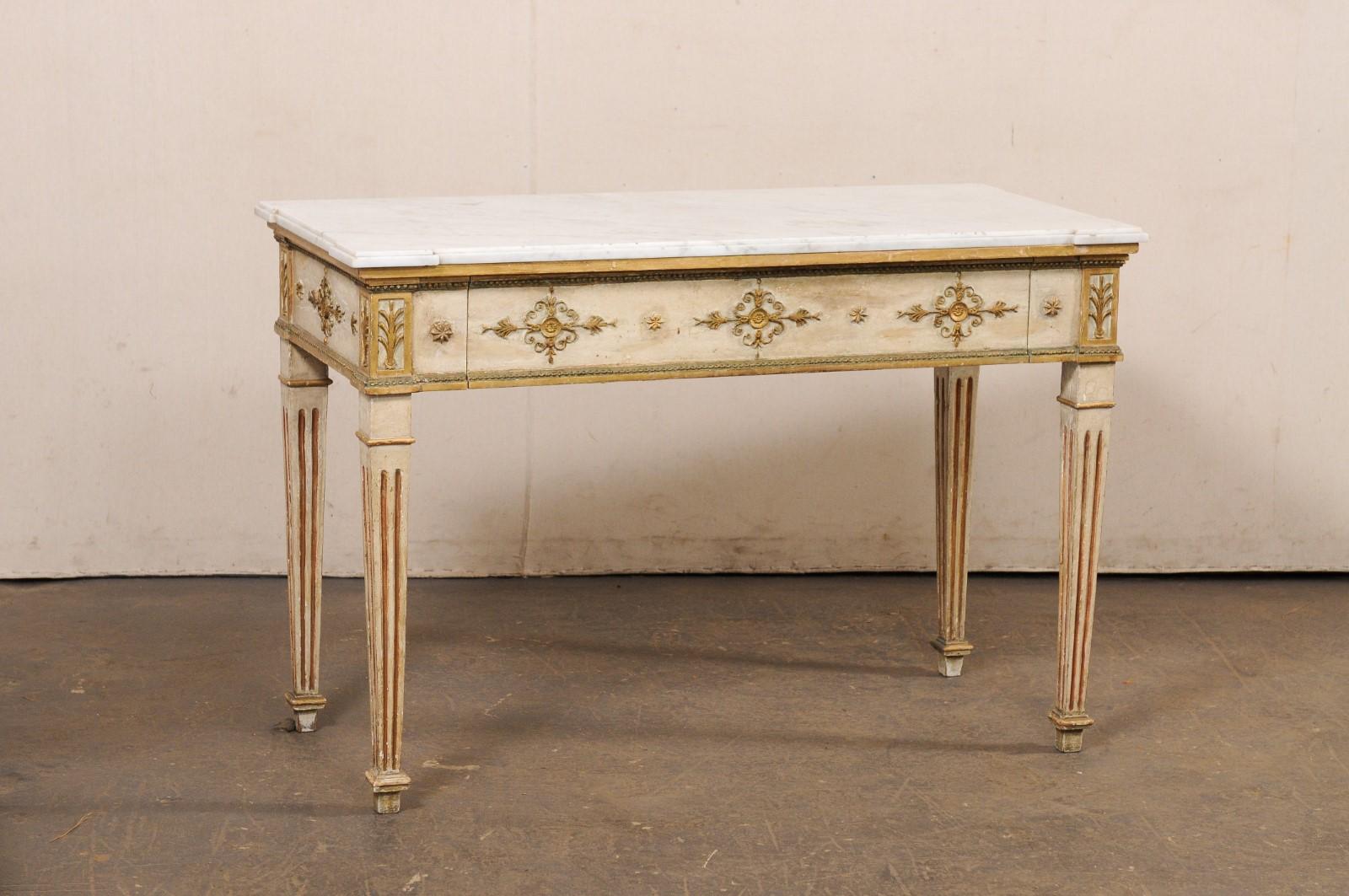 A French Neoclassical console table, with original finish and marble, from the early 19th century. This antique table from France has rectangular-shaped white marble top (with subtly-projected corners that add interest to the top) which rests upon