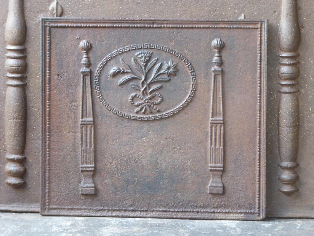 19th century French neoclassical fireback with two pillars and a floral decoration. The pillars stand for freedom, one of the three values of the French revolution.

The fireback is made of cast iron and has a natural brown patina. Upon request it