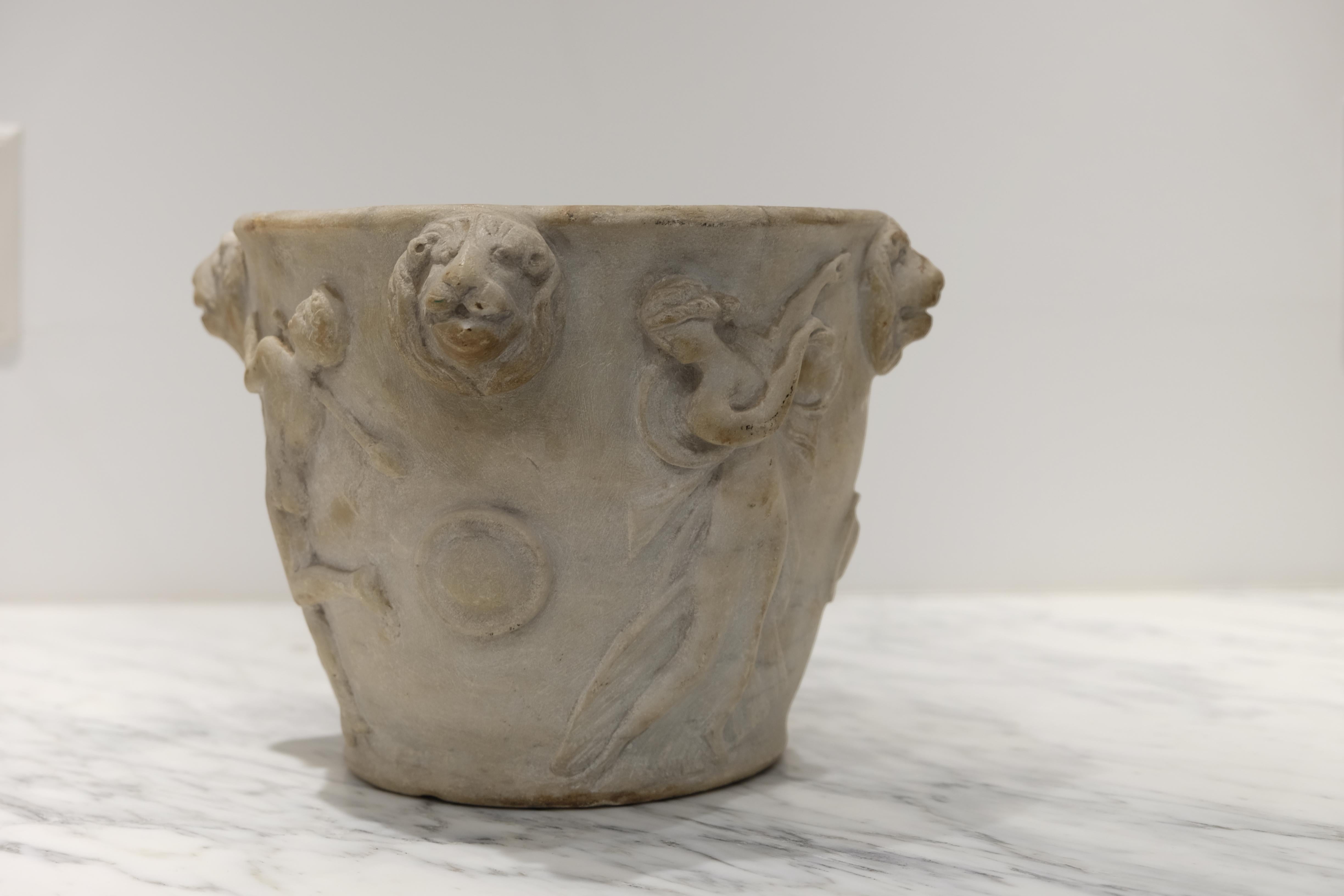 A very impressive late 18th-early 19th century hand carved Italian neoclassical style planter adorned with figures of nymphs and four lion masks. Beautifully chiseled and stippled interior. Interior diameter of 8