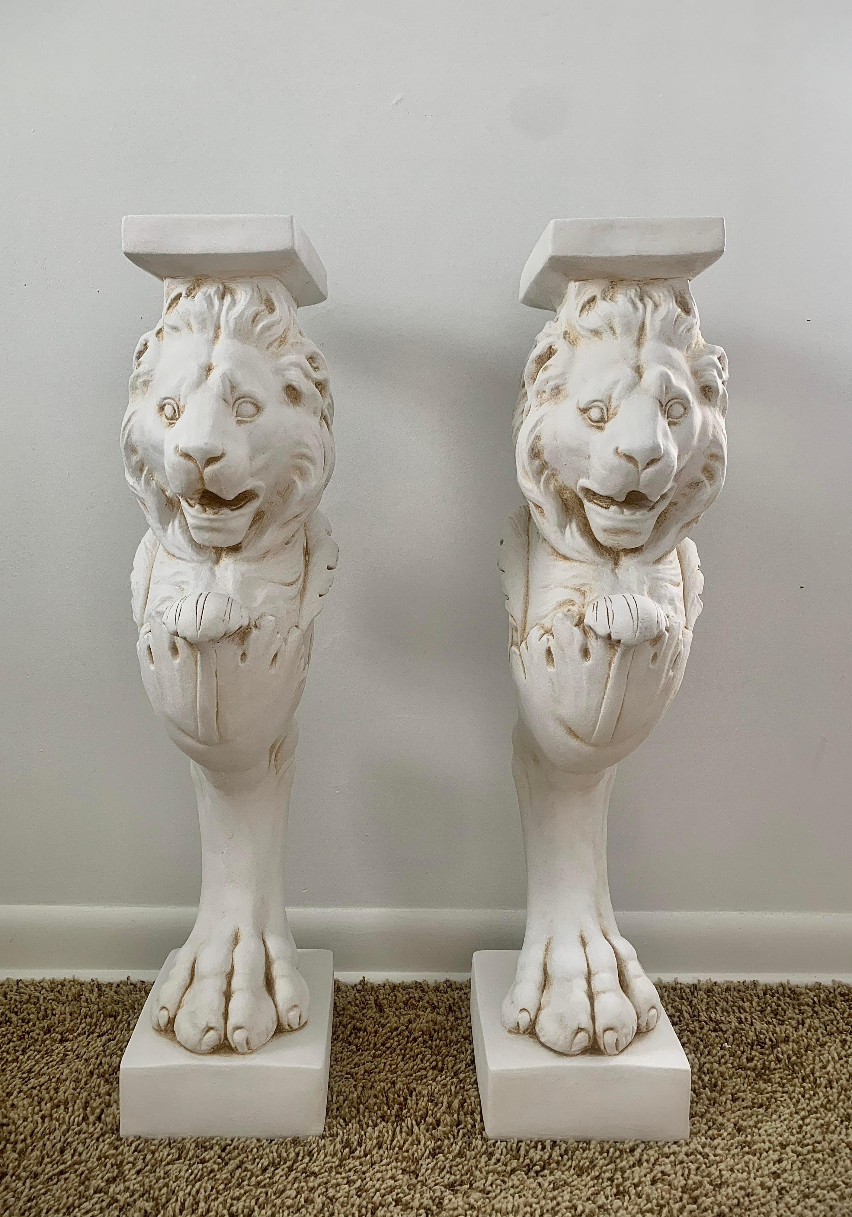 A pair of cast plaster neoclassical style Roman lion pedestals, for use on their own or to hold a tabletop to create a console table. These pedestals could support a marble, zinc, or glass top.

USA, Early 21st Century

Measures: 6.75
