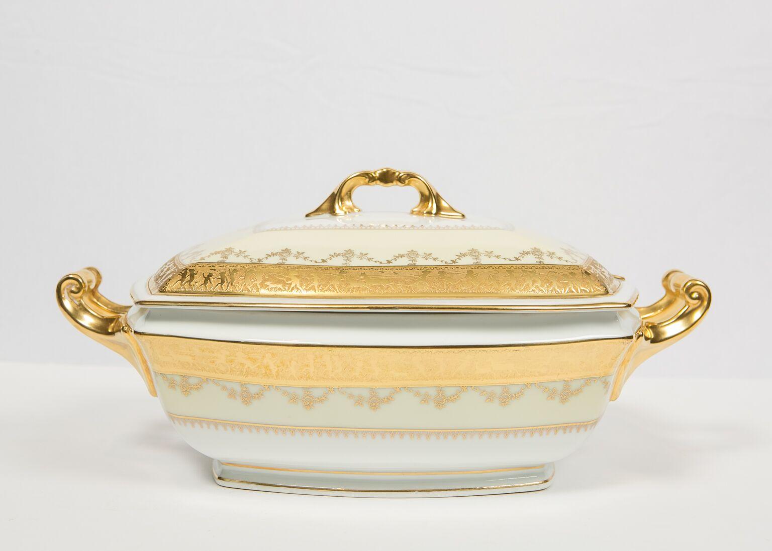 This lovely soup tureen is decorated with two finely wrought gold bands of raised silhouettes of children in a celebratory procession. It is joyous! Some of the children play musical instruments, some carry flags, and others ride in horse drawn