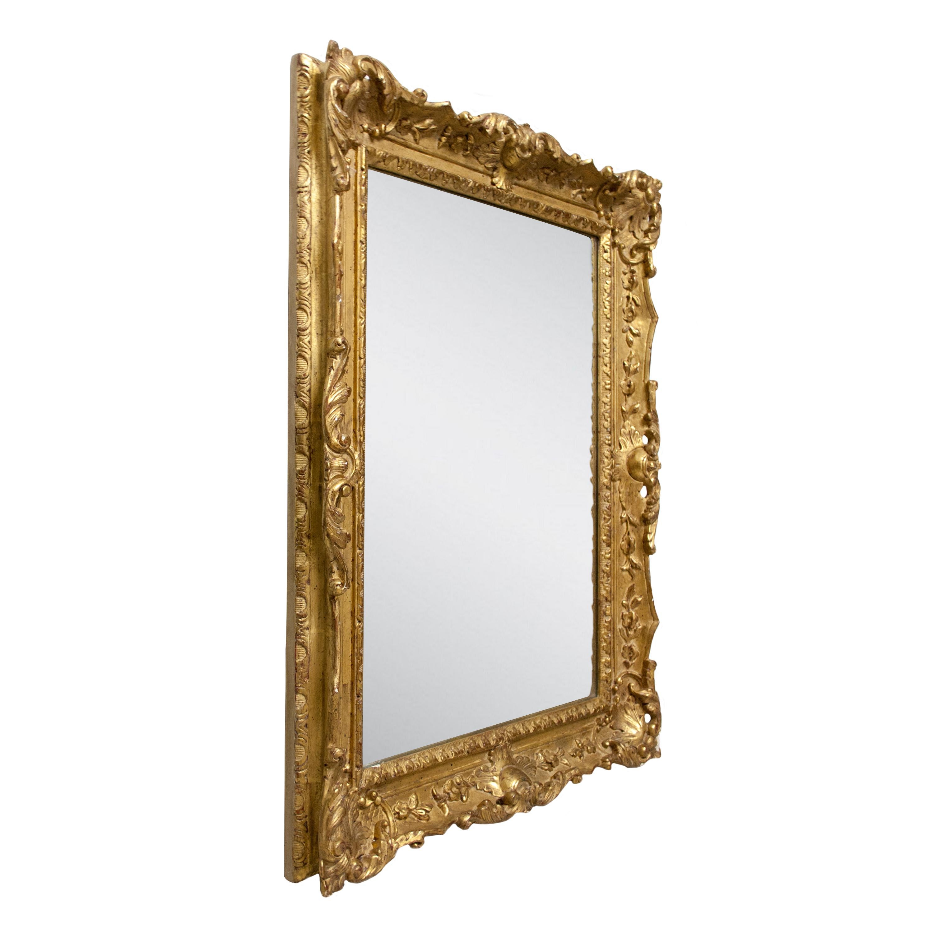 Neoclassical style handcrafted mirror. Rectangular hand carved wooden structure with gold foiled finish, Spain, 1970.