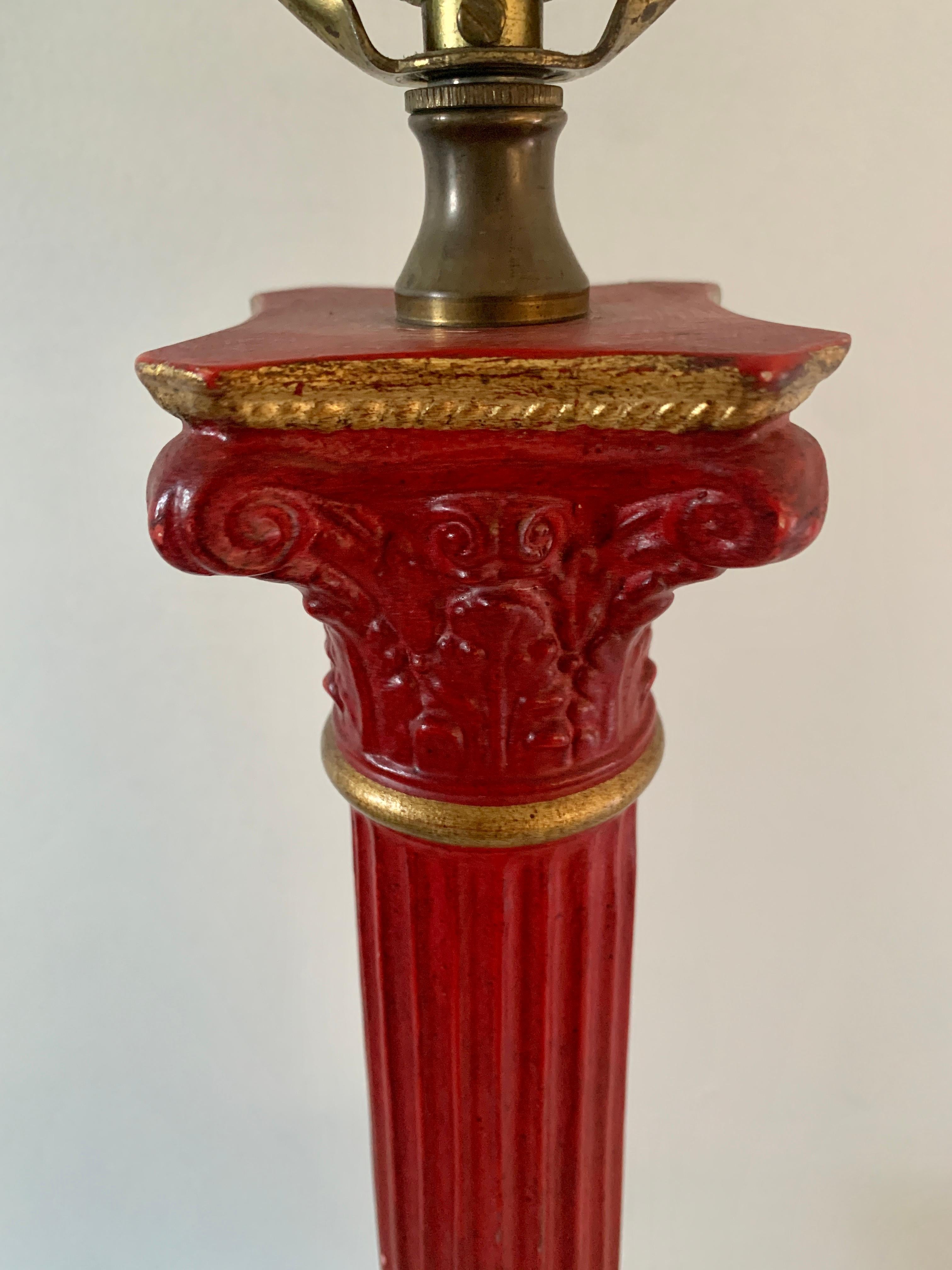 A gorgeous Neoclassical style red and gold corinthian column table lamp with laurel wreath accent

USA, Mid-20th Century

Measures: 5.25