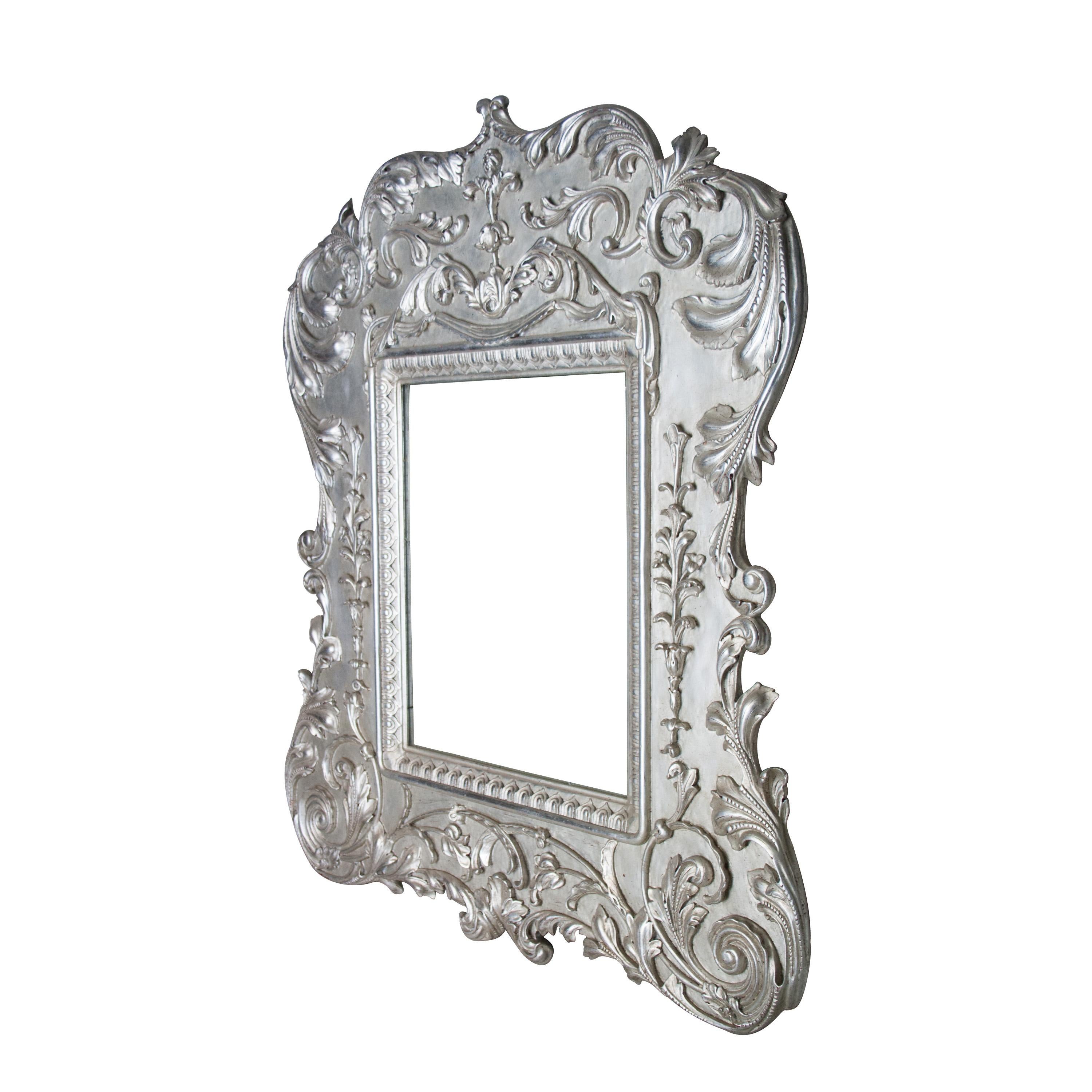 Neoclassical Regency Empire style handcrafted mirror. Hand carved wooden structure with silver foiled finish. Spain, 1970.