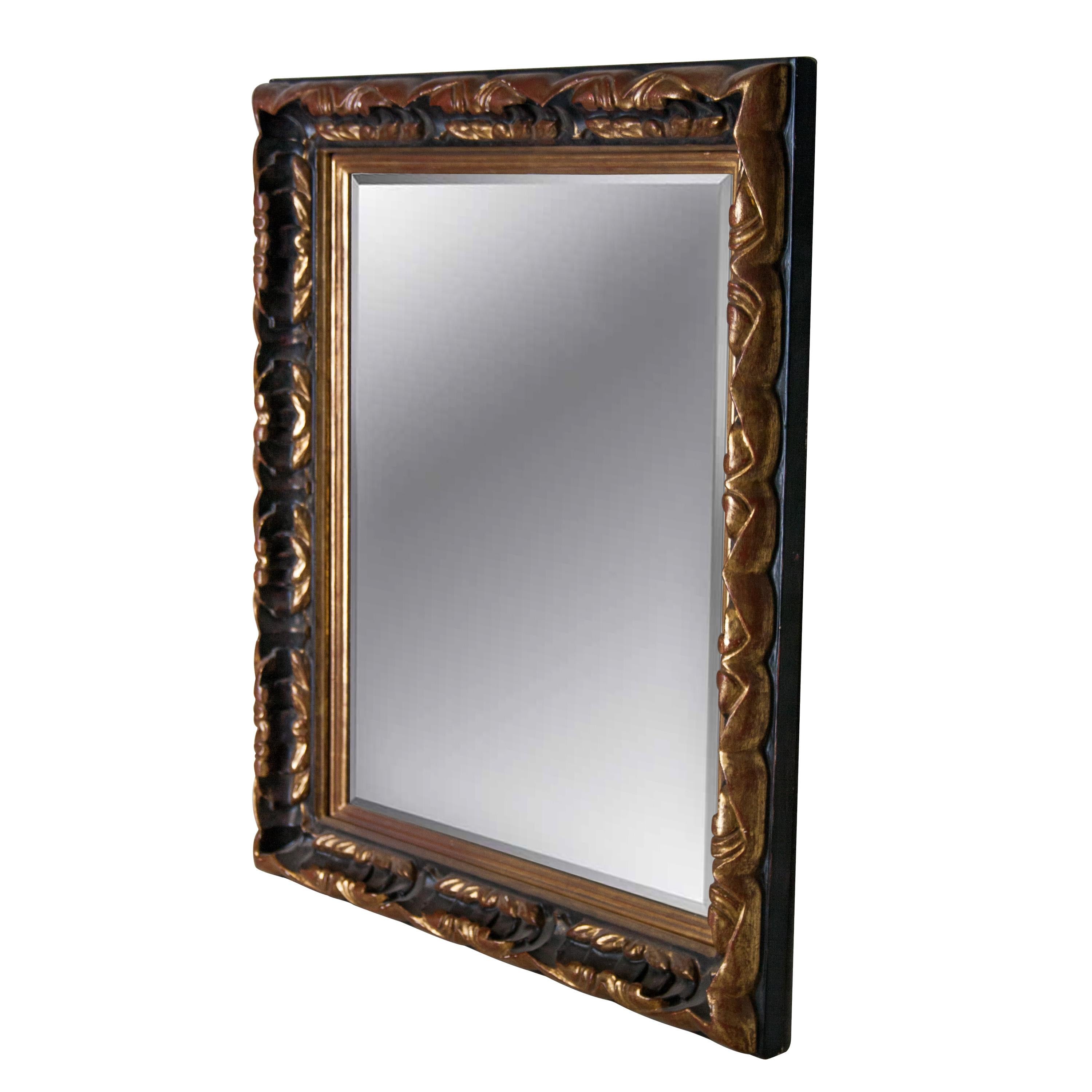 Neoclassical Empire style handcrafted mirror. Rectangular hand carved wooden structure with gold foiled and black finish. Spain, 1970.