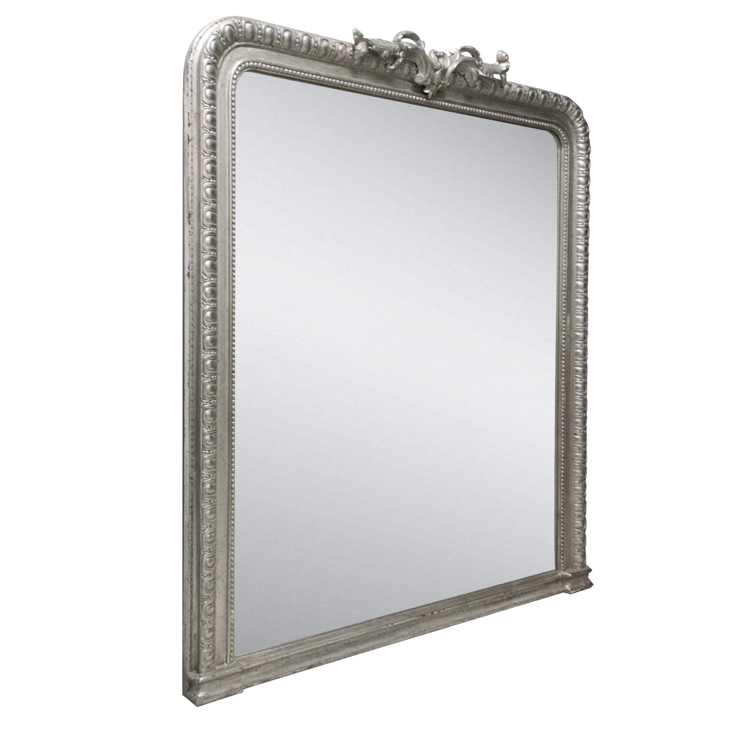 Neoclassical Regency style handcrafted mirror. Rectangular hand carved wooden structure with silver foiled finish. Spain, 1970.