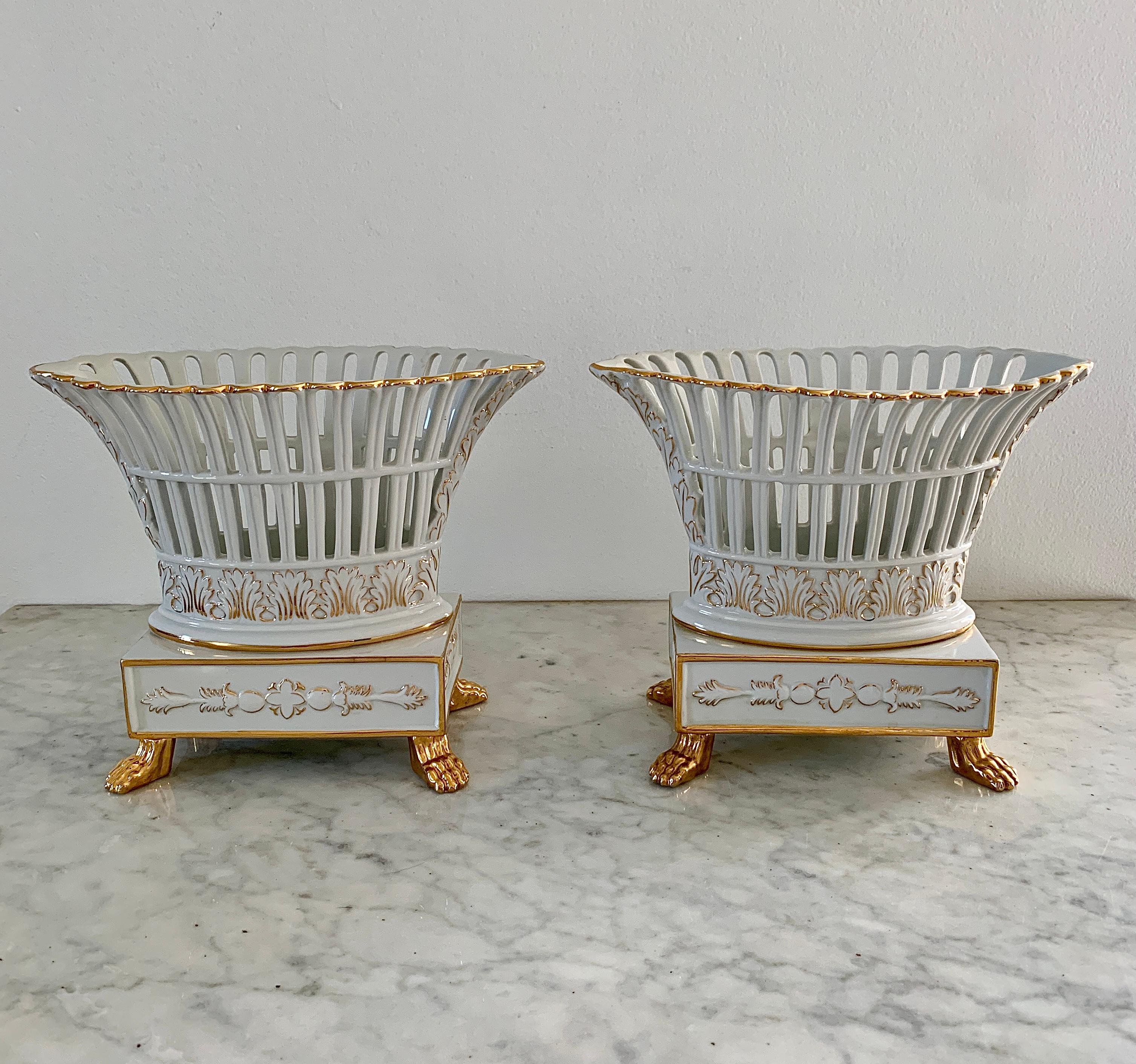 A gorgeous pair of white & gold regency style reticulated porcelain basket compotes with lion paw feet

Circa late 20th century.

Measures: 9.25