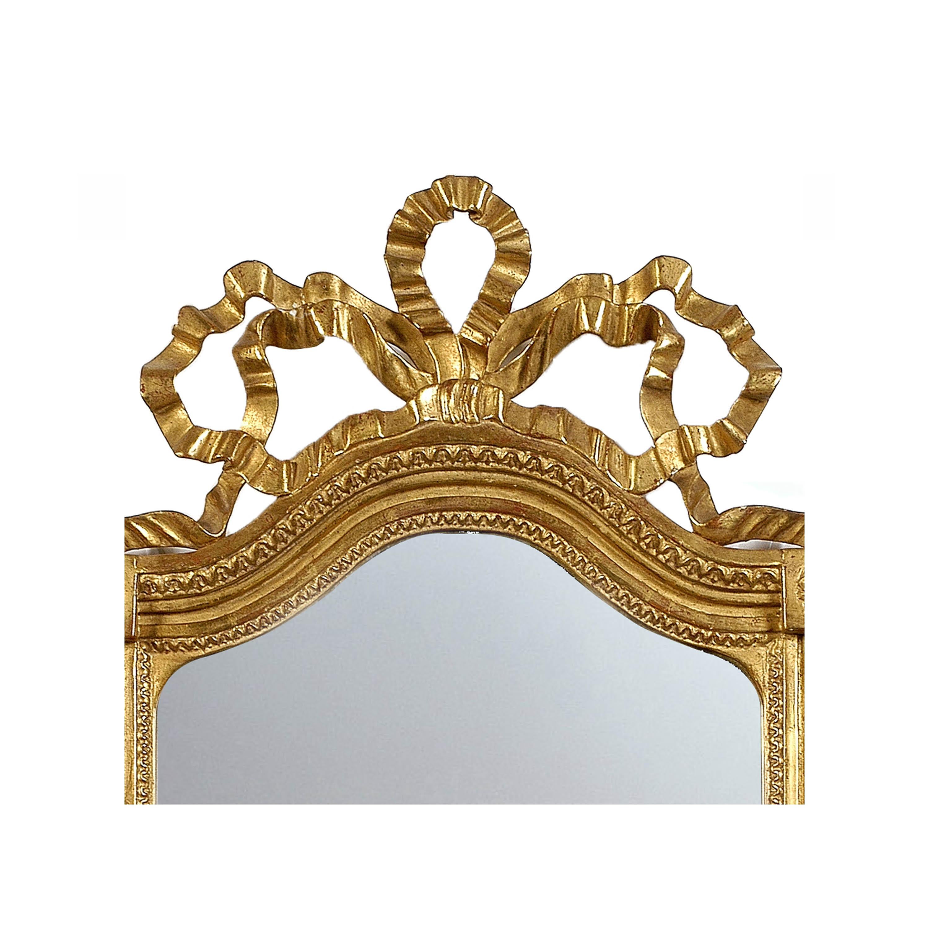 Neoclassical Regency style handcrafted mirror. Rectangular and carved wooden structure with gold foil finished. Spain, 1970.