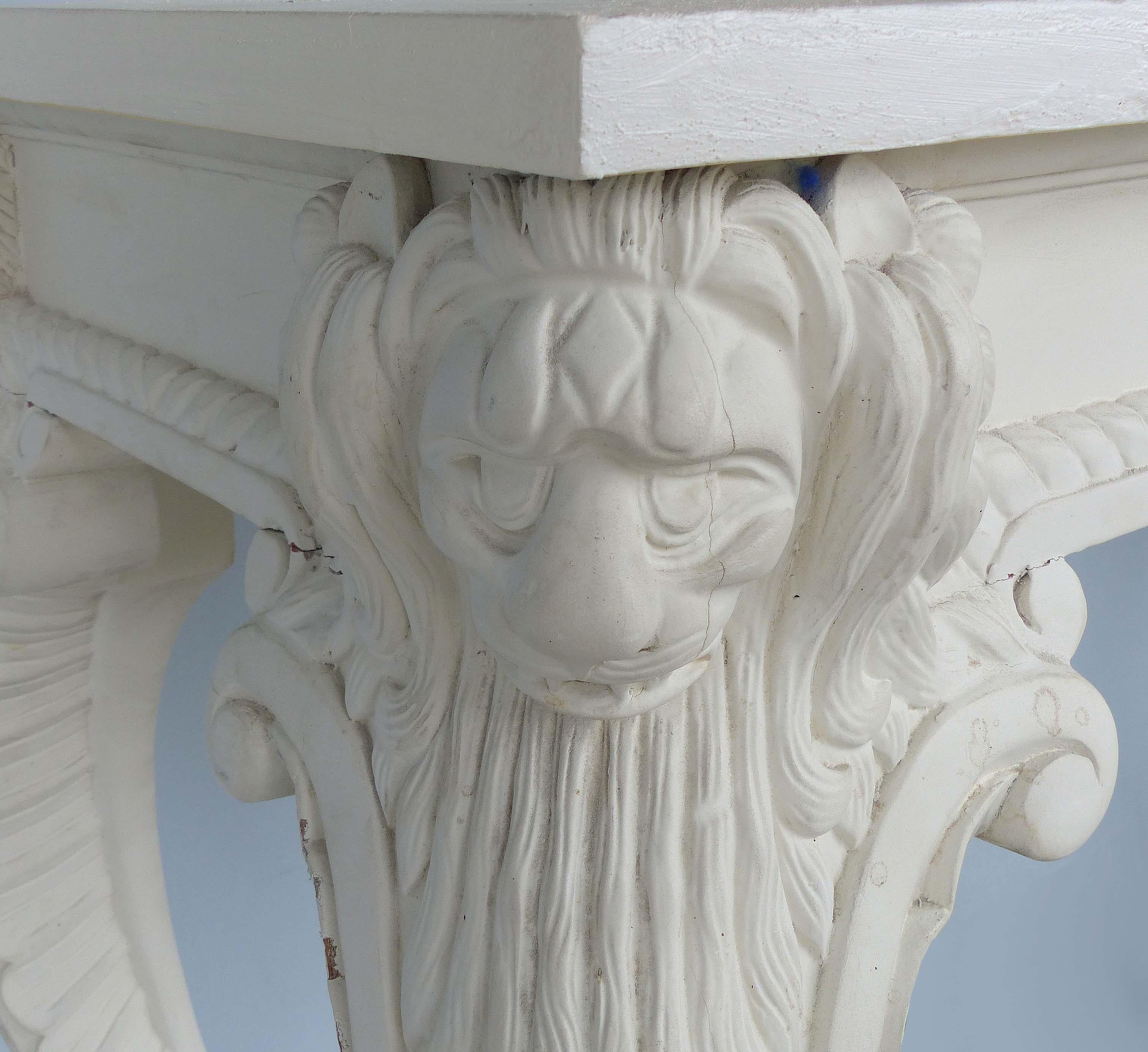 Offered for sale is a painted and carved neoclassical revival style console table. The console is rustically painted a warm white with age wear to the finish as shown. This would be a great piece to paint.