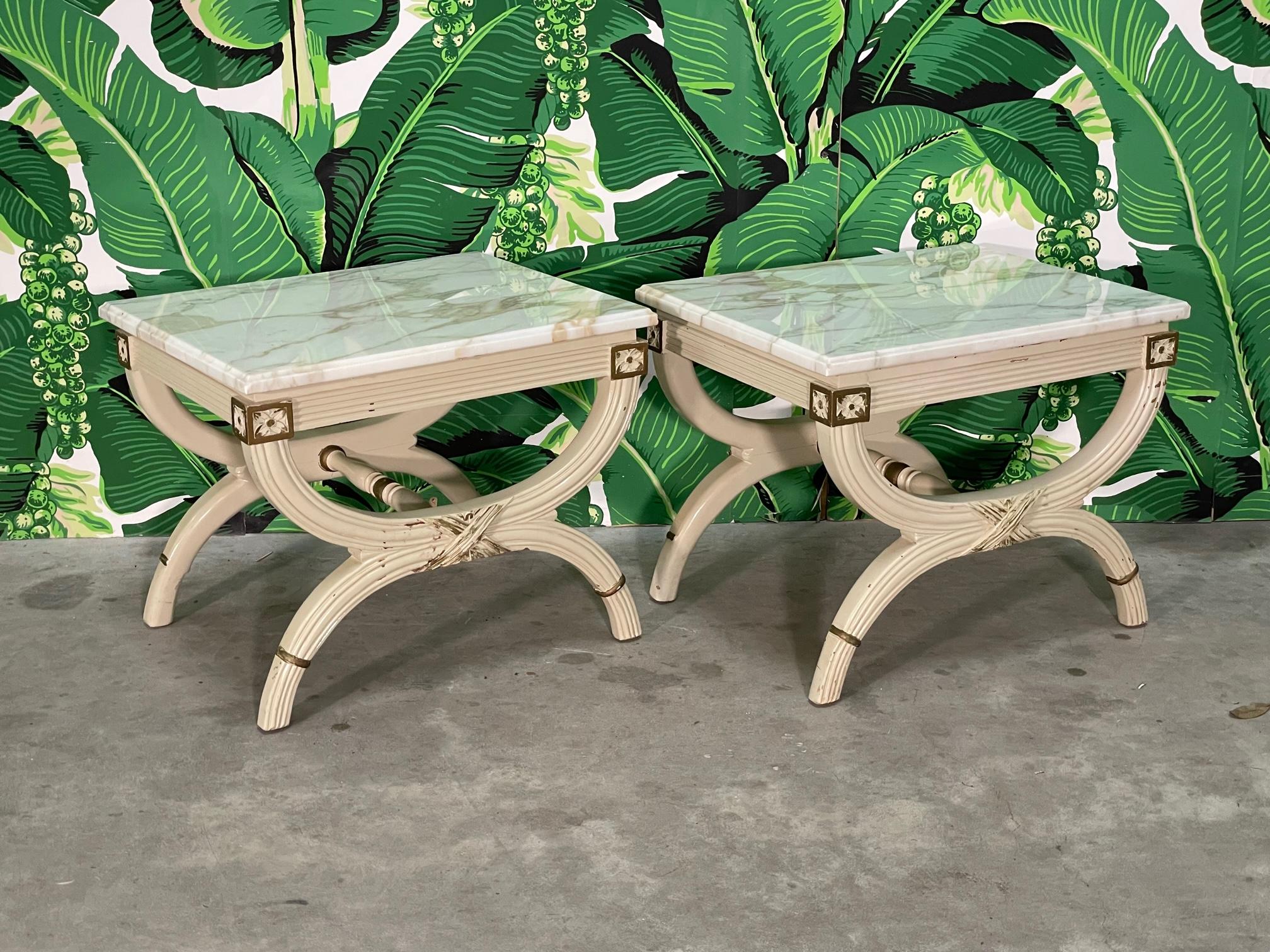 Pair of carved wood end tables feature a marble top and a neoclassical design similar to pieces by Dorothy Draper. Could be used as footstools, marble lifts off and could be replaced by a cushion. Good condition with imperfections consistent with