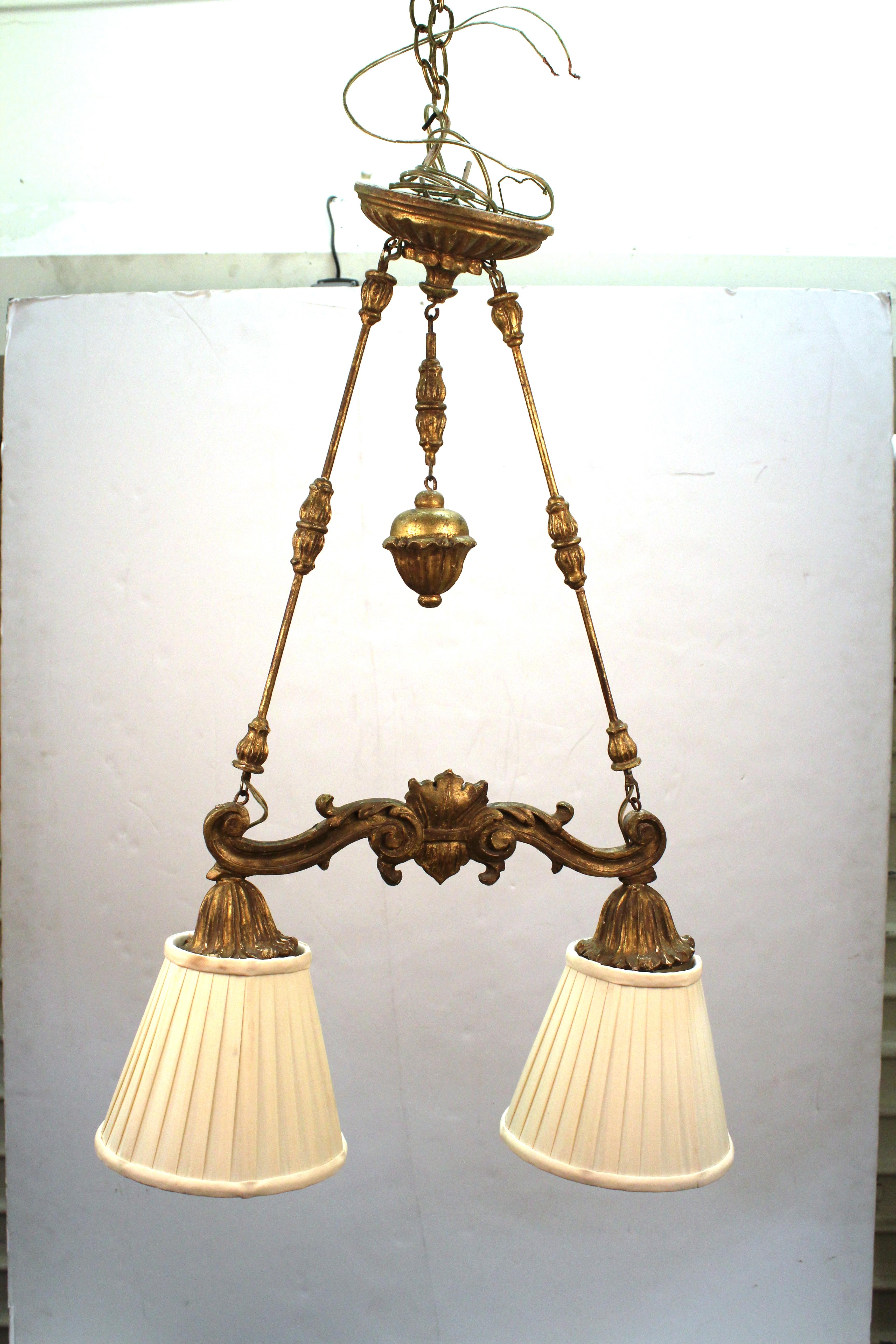 Neoclassical revival gilt wood pendant light chandelier with two shades. The piece was likely made during the late 19th - early 20th Century.

Dealer: S138XX