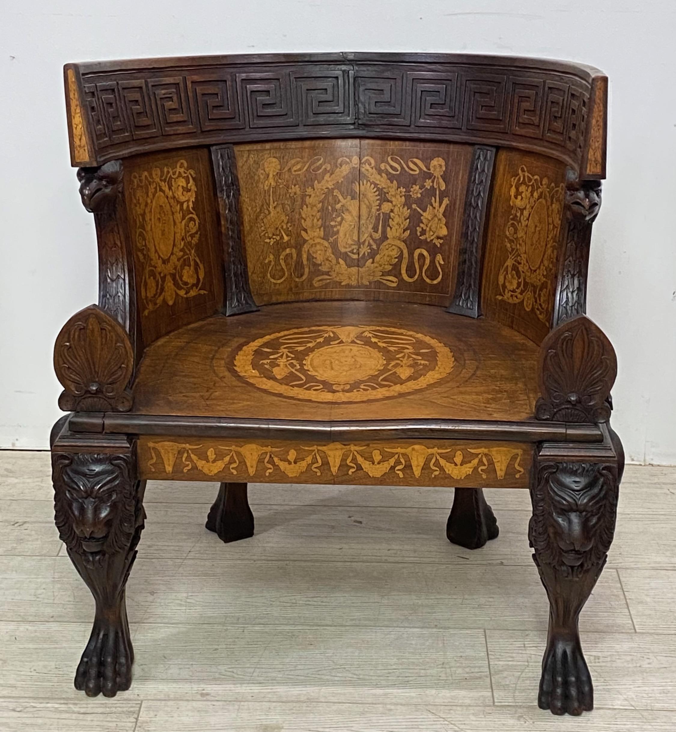 A highly unusual Imperial Revival style Grand Tour period armchair.
Black walnut with walnut and satinwood inlay and pen work detail. Beautifully carved legs and paw feet, and having a Greek Key design along the back. 
In 52 years of being an