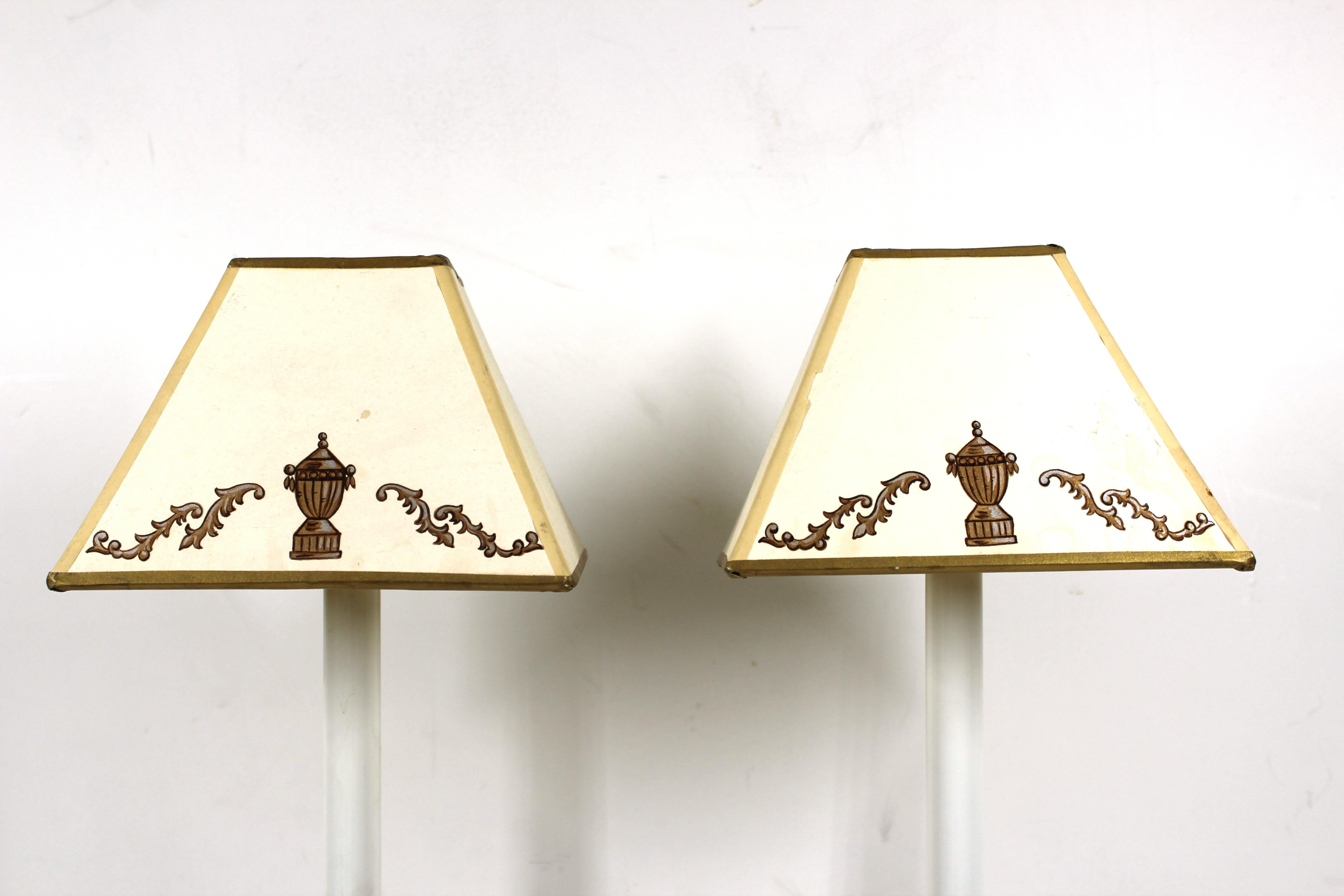 Continental pair of diminutive neoclassical Revival manner candlestick table lamps with partially gilt porcelain column bases and hand painted shades.
