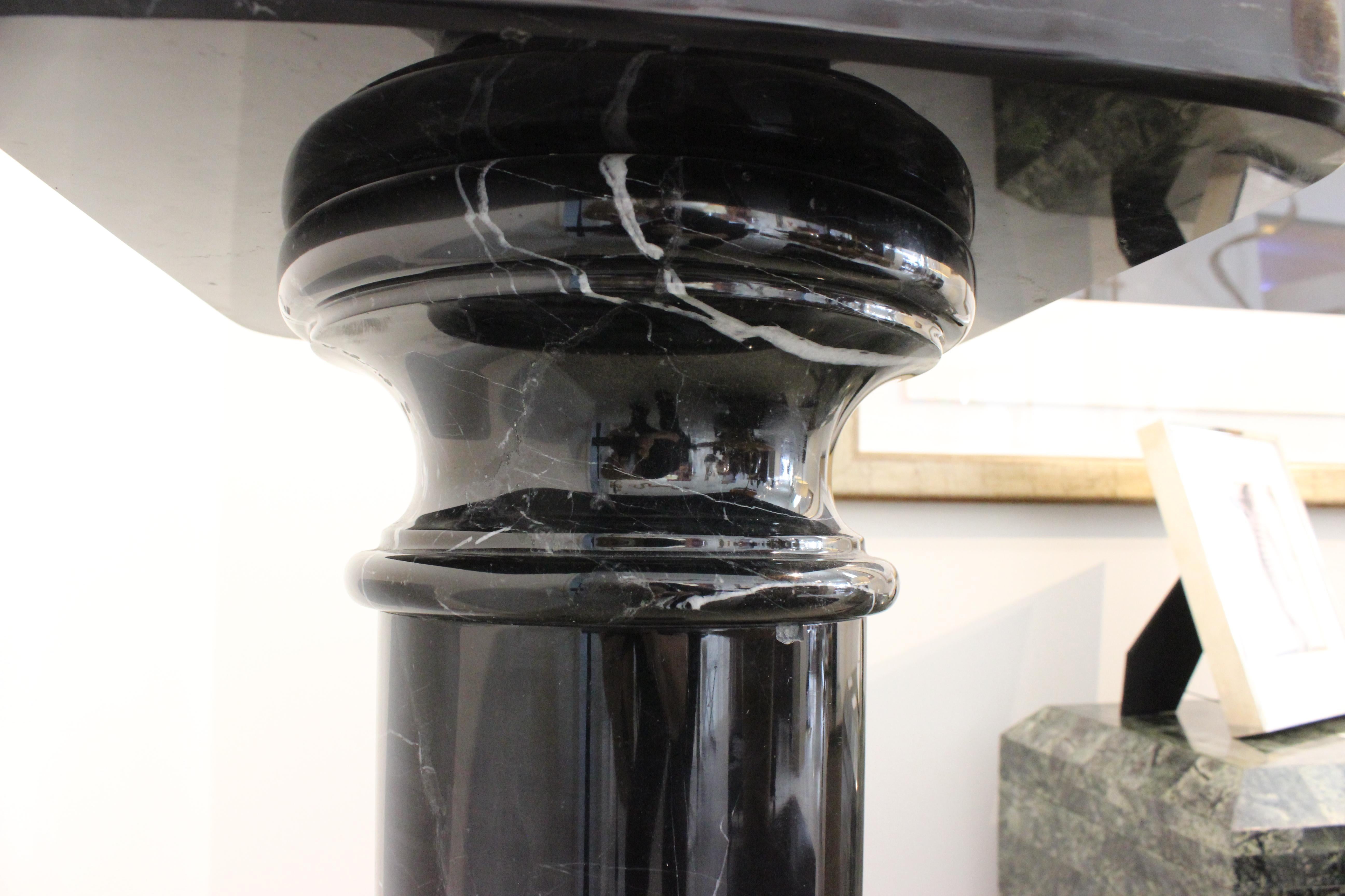 This stylish and dramatic black marble pedestal will make a definite statement with its doric form and use of materials.

Note: There are small veins of white marble.

Note: The top has surface wear, spots and slight scratches (see images).