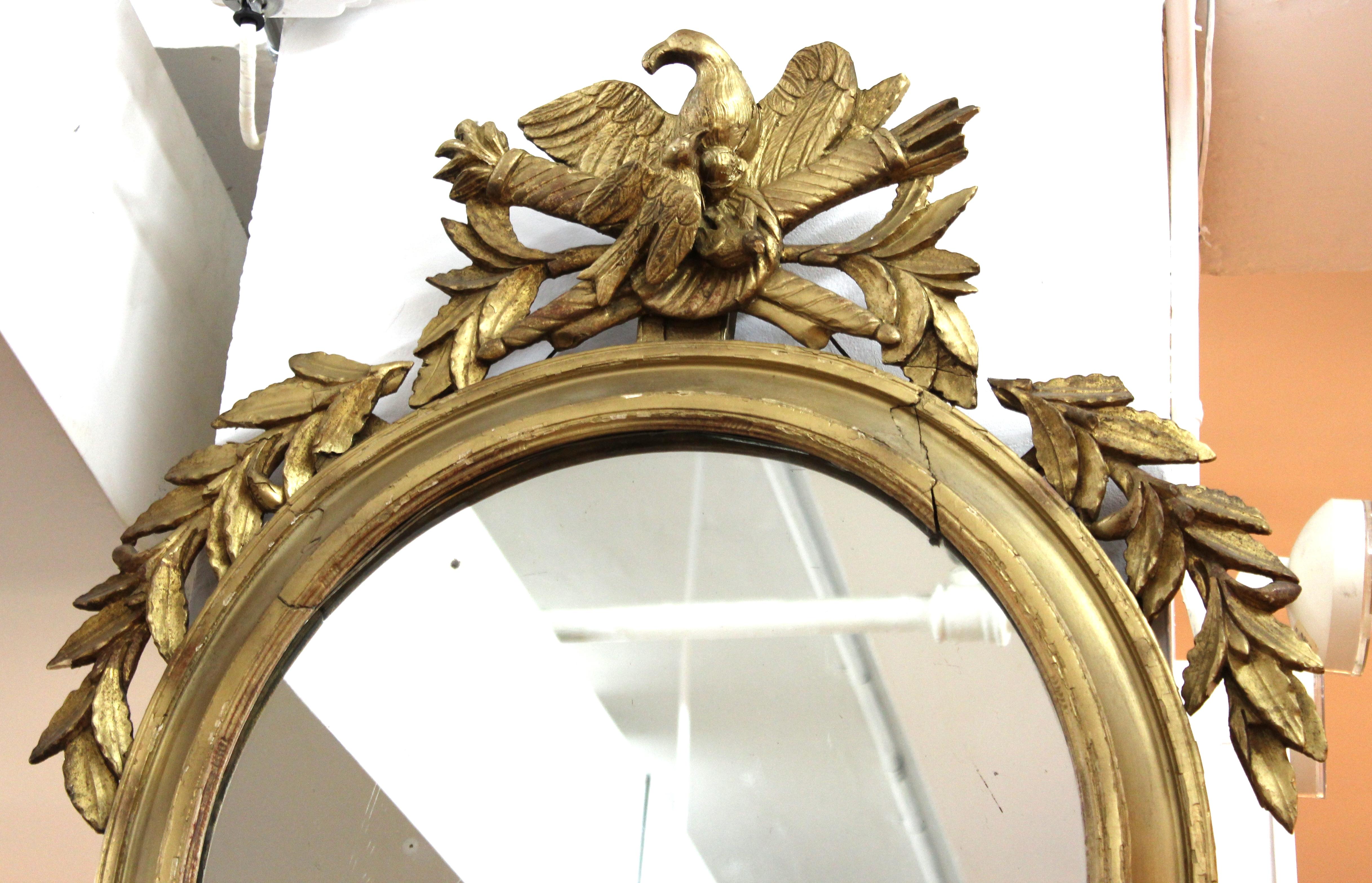Néo-classique Miroir oblongue néoclassique en bois doré avec aigle et trophées en vente