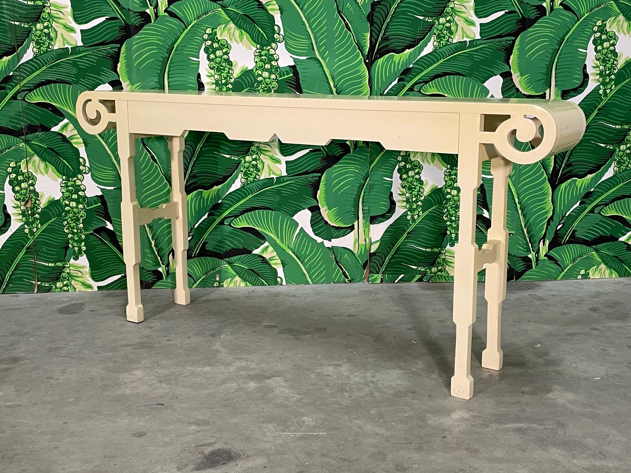 Solid wood console table features a modern take on neoclassical revival style with it's scroll carved top. Good vintage condition imperfections consistent with age, see photos for condition details. 
For a shipping quote to your exact zip code,