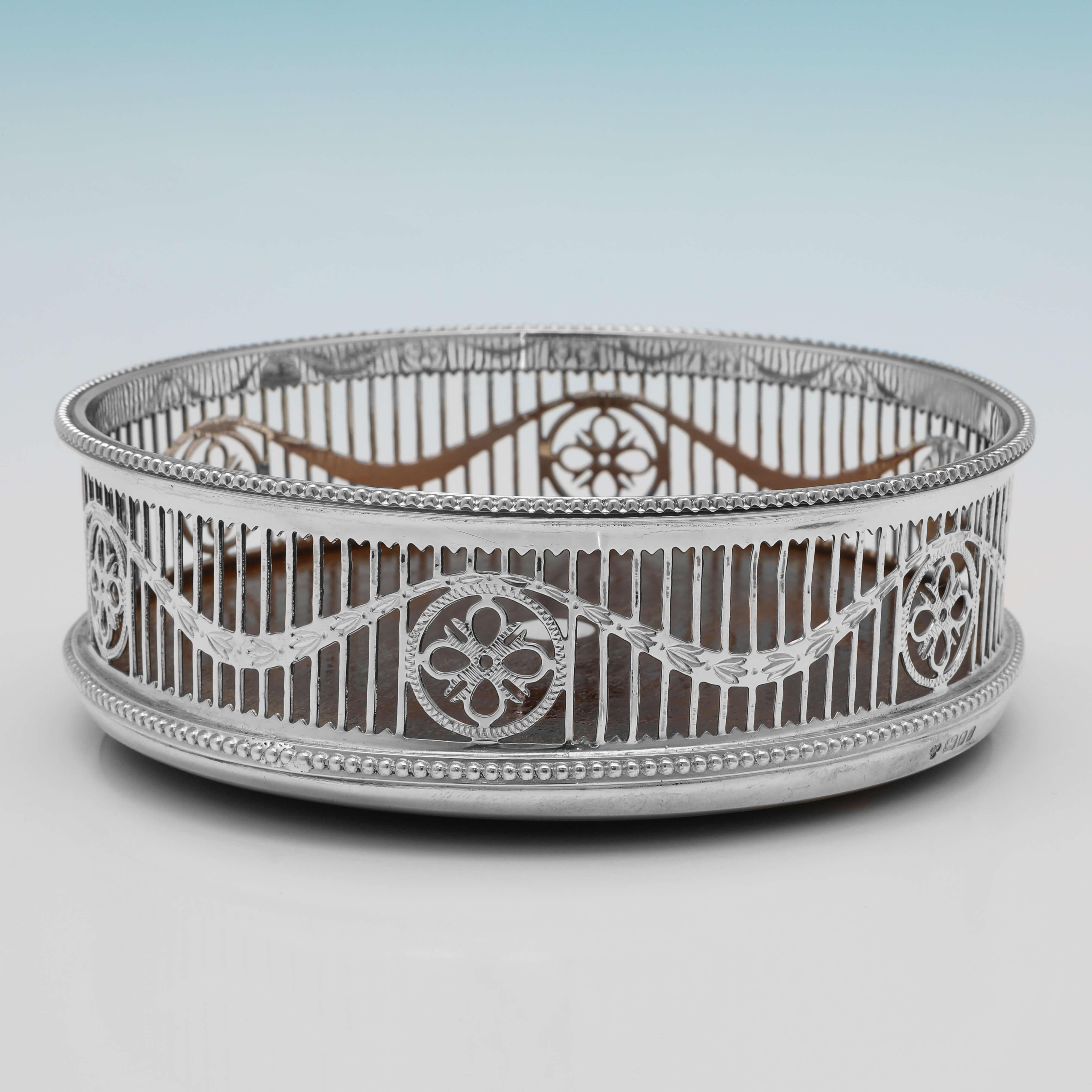 Hallmarked in London in 1985, this charming, Sterling Silver Wine Coaster, is in the Neoclassical Revival style. The wine coaster measures 1.75