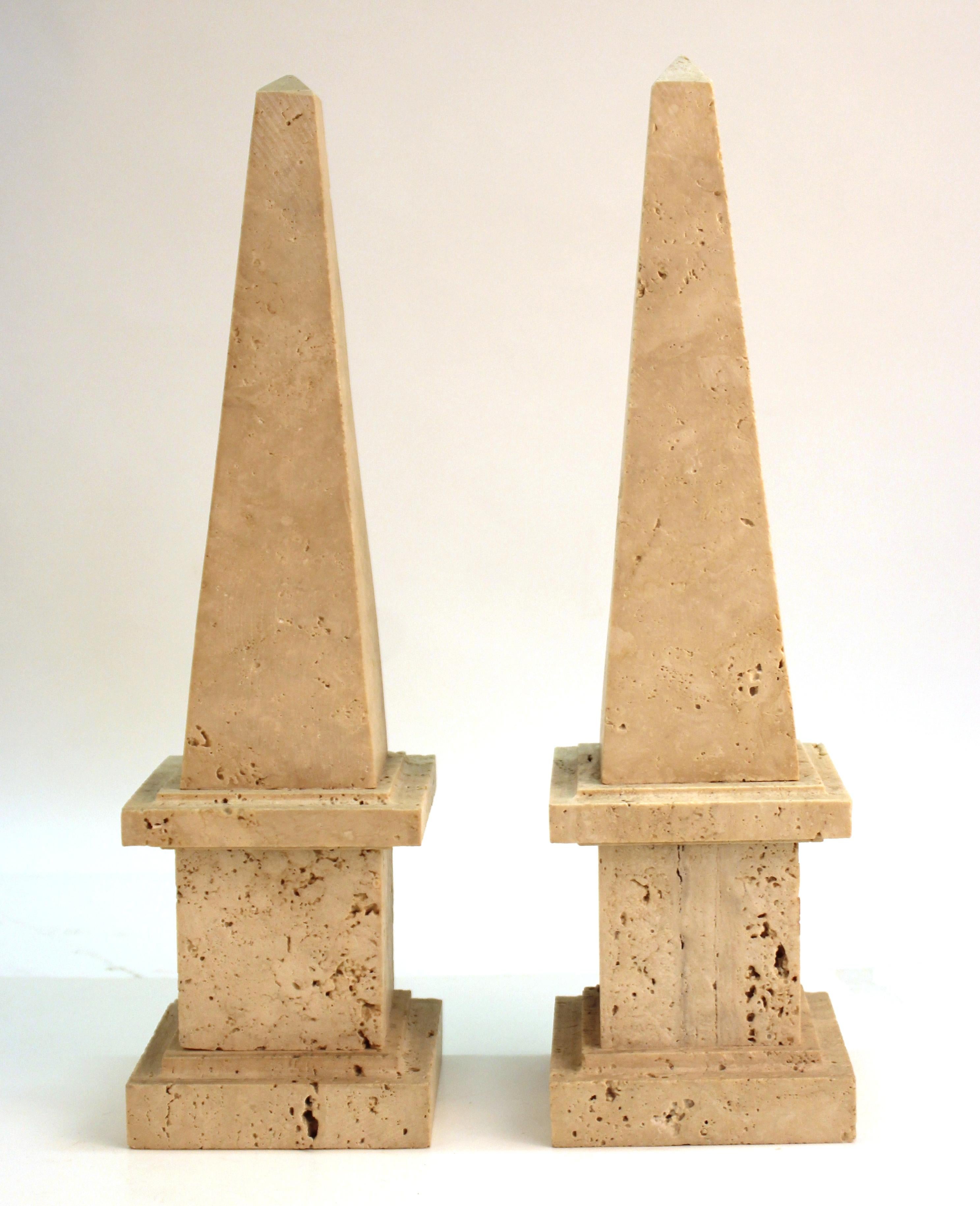 Neoclassical revival pair of stone obelisks. The pair was made in the 20th century and is in great vintage condition, with age-appropriate wear to the surfaces.